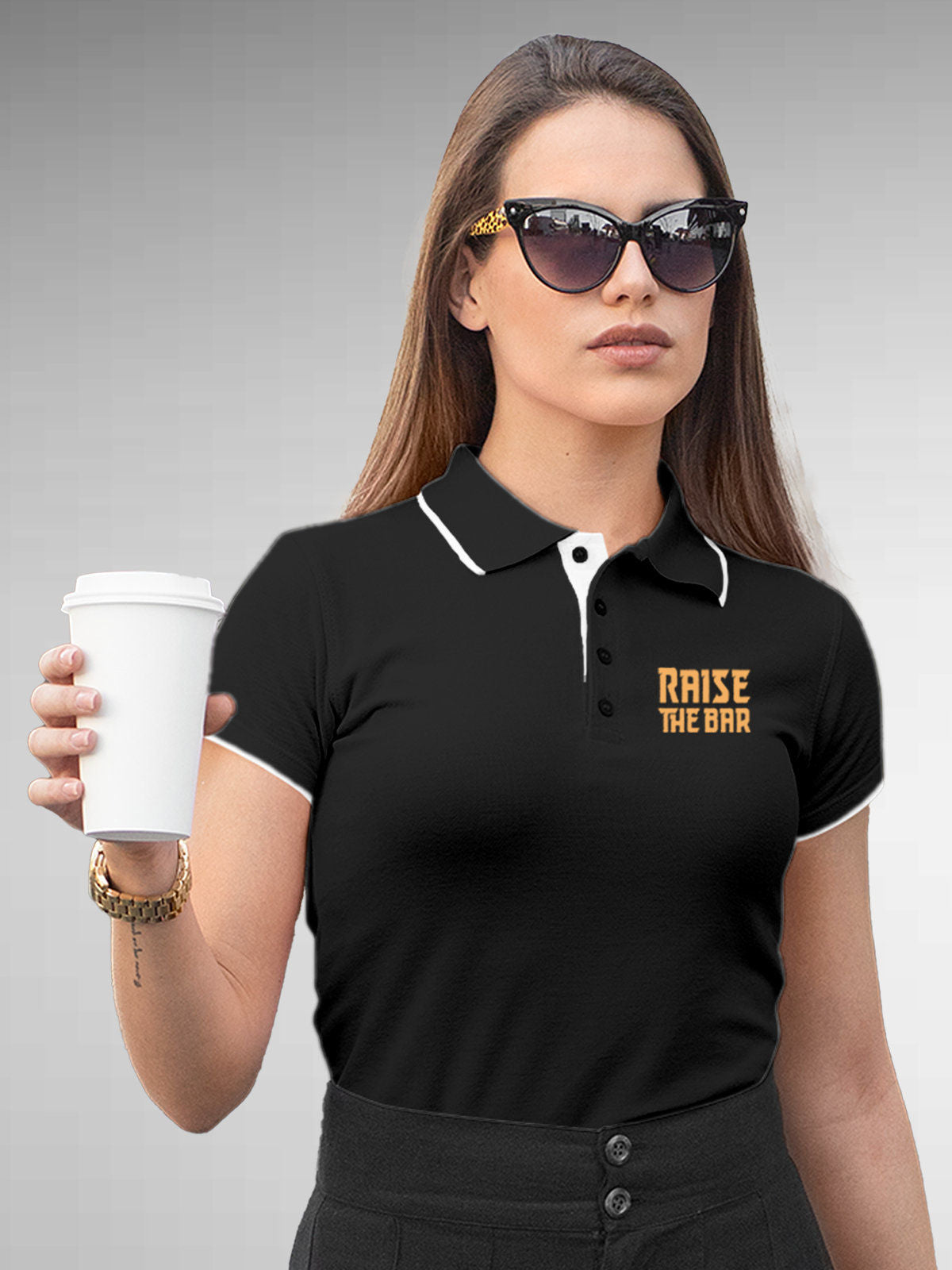 Model wearing Women's Dark Grey Polo T-shirt with 'Raise The Bar' design, offering effortless style and premium comfort