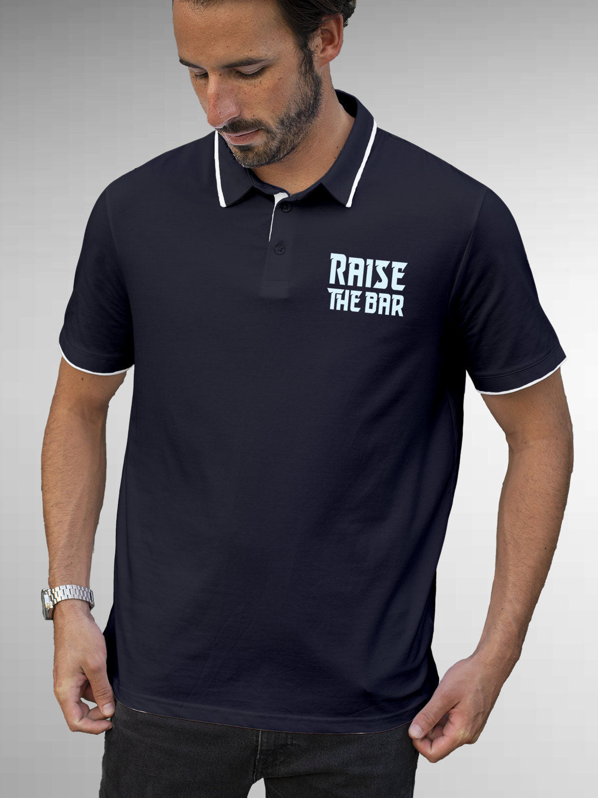Model wearing Men's Navy Blue Polo T-shirt with 'Raise The Bar' design, offering effortless style and premium comfort