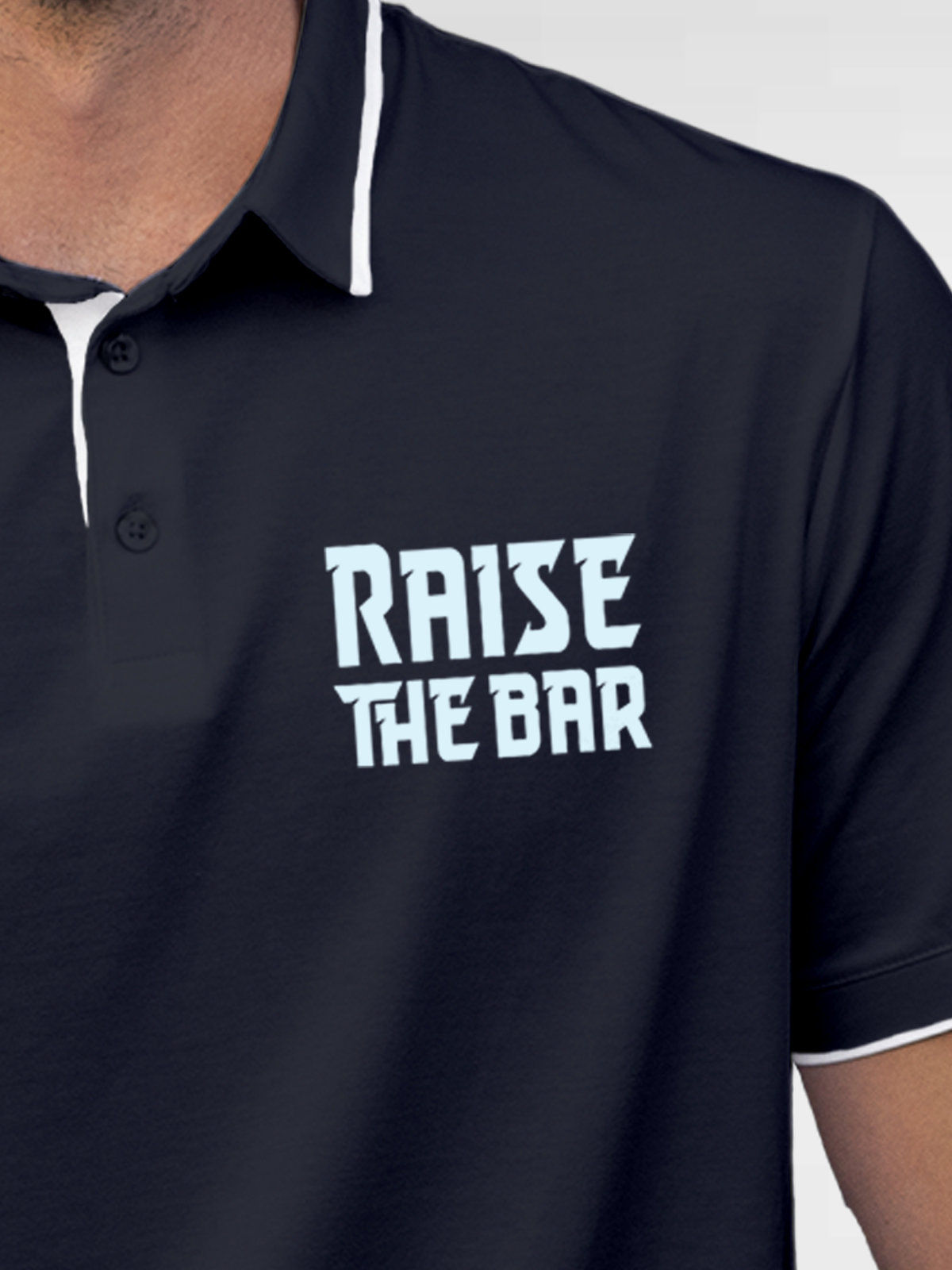 Close up of 'Raise The Bar' design on Men's Navy Blue Polo T-shirt, highlighting intricate details and vibrant print.