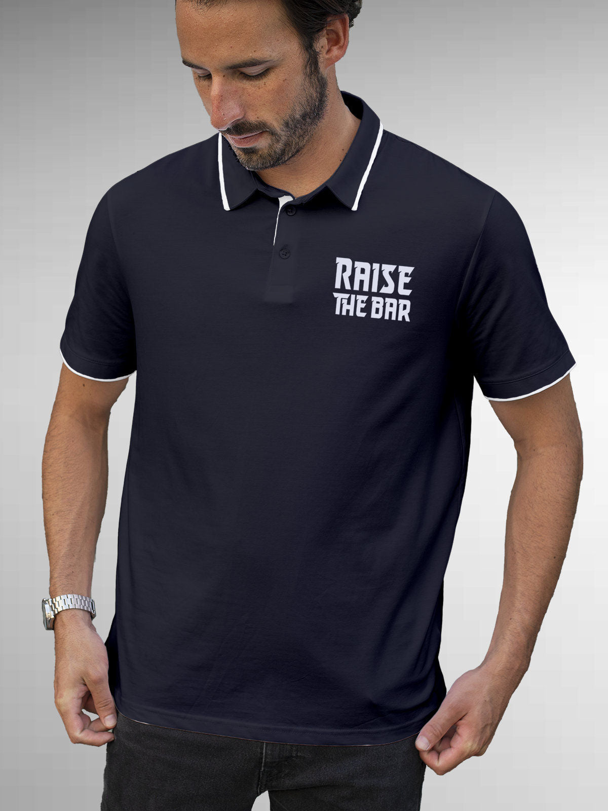 Model wearing Men's Navy Blue Polo T-shirt with 'Raise The Bar' design, offering effortless style and premium comfort