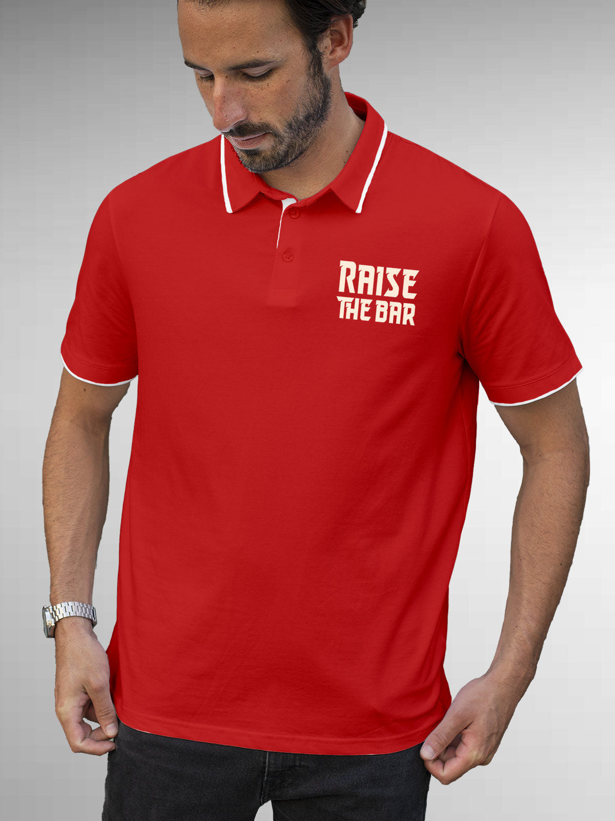 Model wearing Men's Red Polo T-shirt with 'Raise The Bar' design, offering effortless style and premium comfort