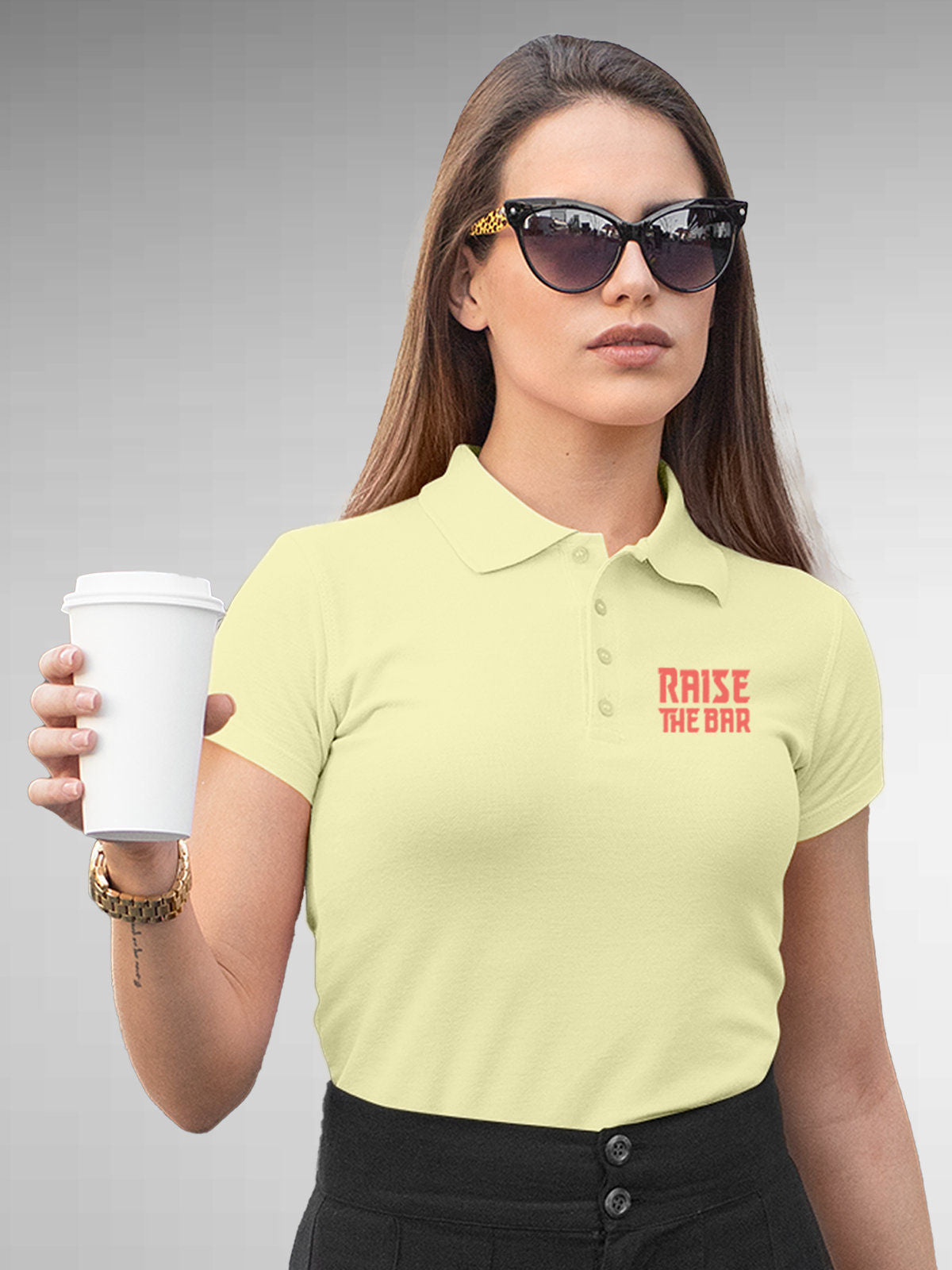 Model wearing Women's Yellow Polo T-shirt with 'Raise The Bar' design, offering effortless style and premium comfort