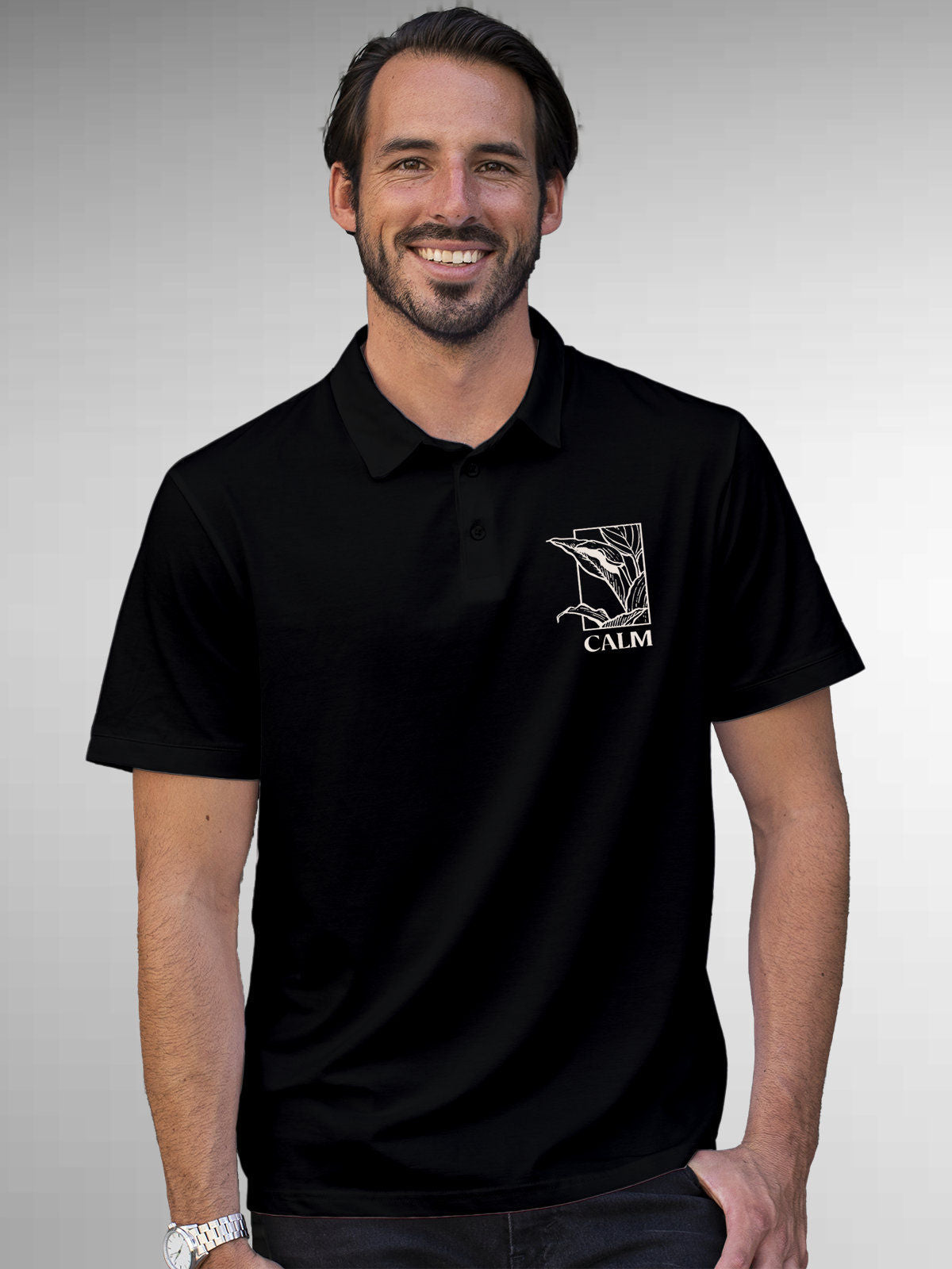 Model wearing Men's Black Polo T-shirt with 'Calm' design, offering effortless style and premium comfort