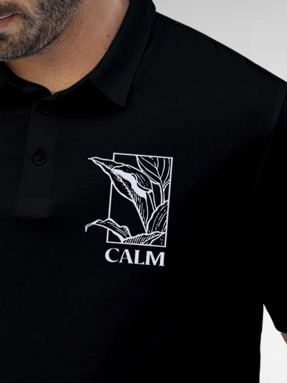 Close up of 'Calm' design on Men's Black Polo T-shirt, highlighting intricate details and vibrant print.