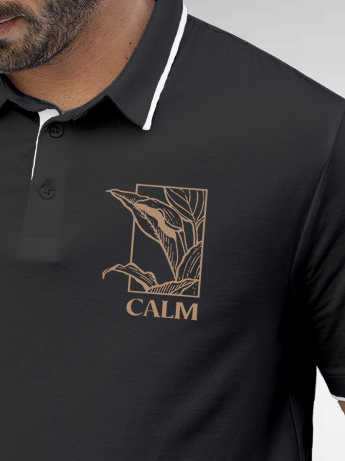 Close up of 'Calm' design on Men's Dark Grey Polo T-shirt, highlighting intricate details and vibrant print.