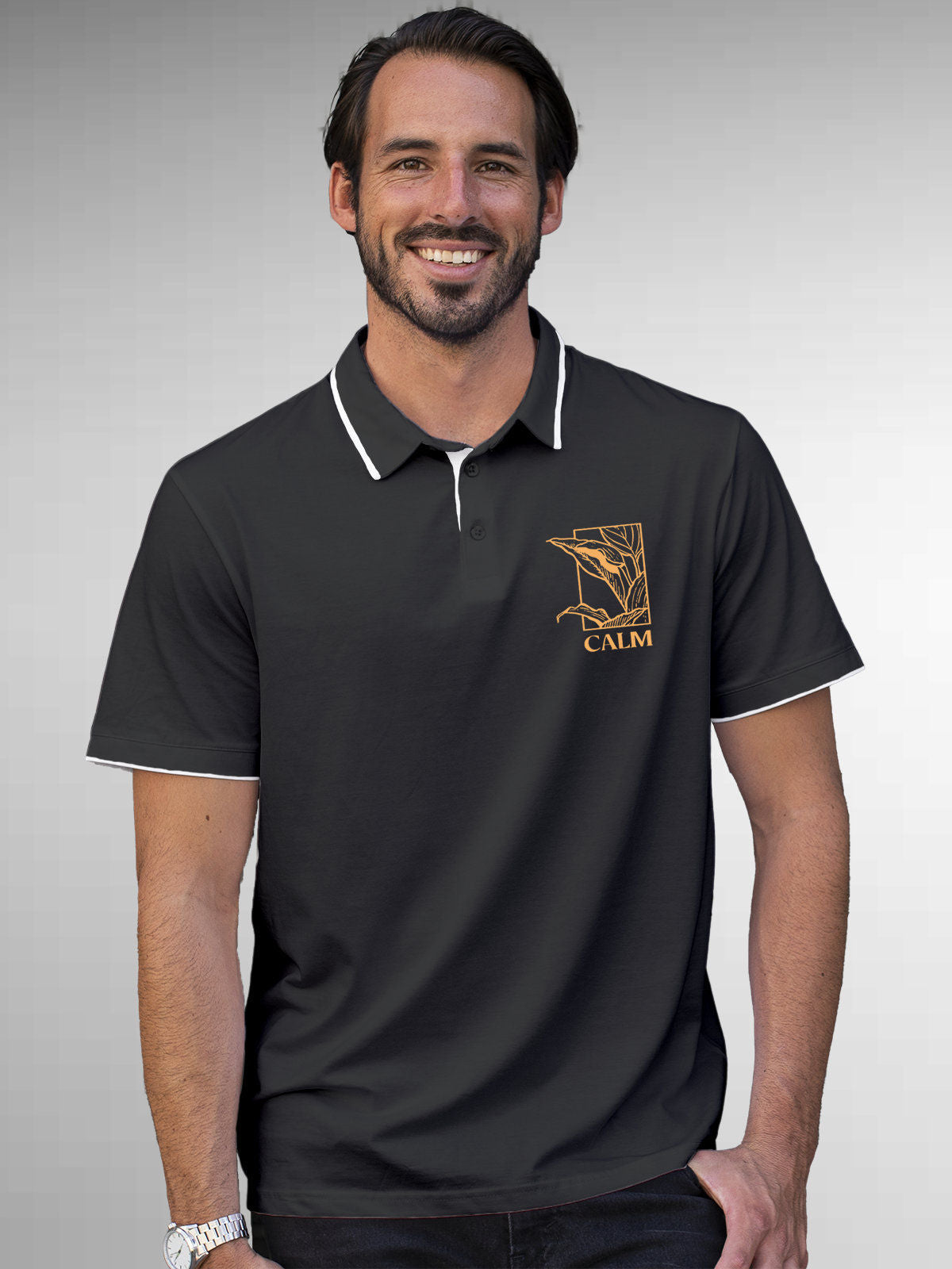 Model wearing Men's Dark Grey Polo T-shirt with 'Calm' design, offering effortless style and premium comfort