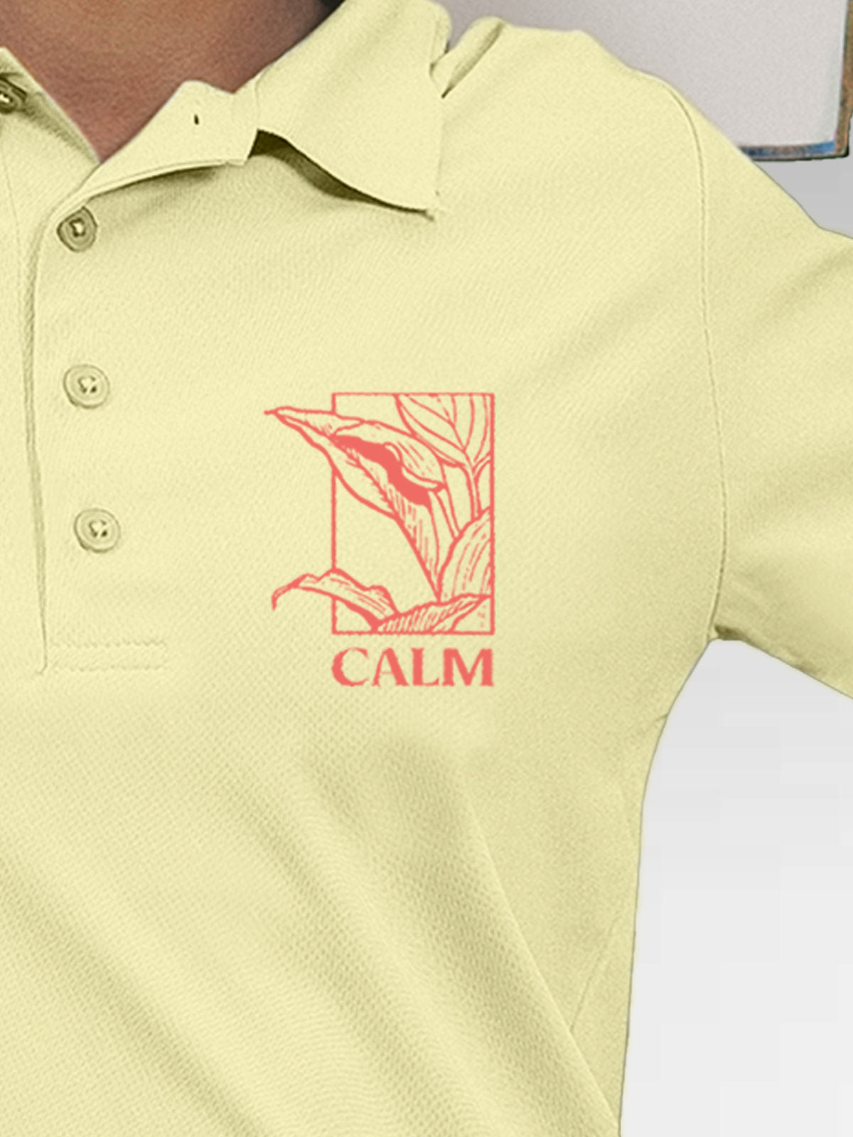 Close up of 'Calm' design on Women's Yellow Polo T-shirt, highlighting intricate details and vibrant print.