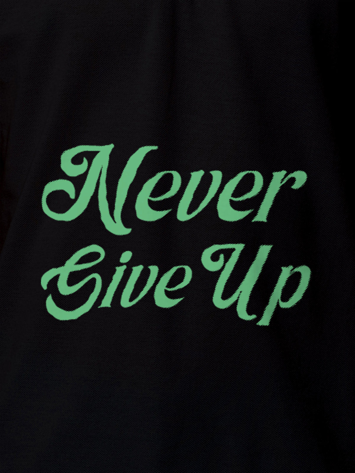 Close up of 'Never Give Up' design on Men's Black Polo T-shirt, highlighting intricate details and vibrant print.