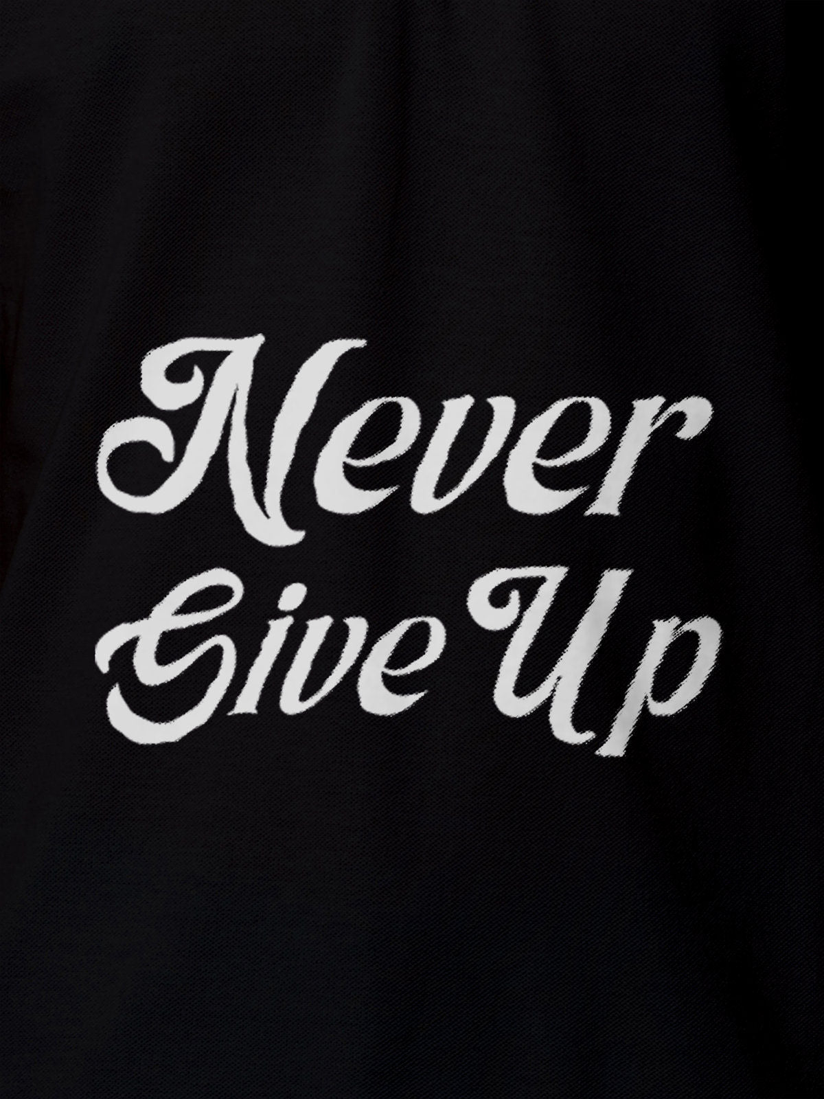 Close up of 'Never Give Up' design on Men's Black Polo T-shirt, highlighting intricate details and vibrant print.