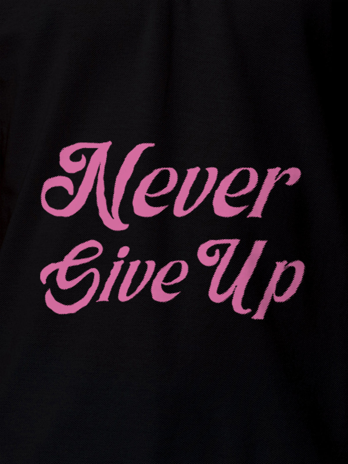 Close up of 'Never Give Up' design on Men's Black Polo T-shirt, highlighting intricate details and vibrant print.