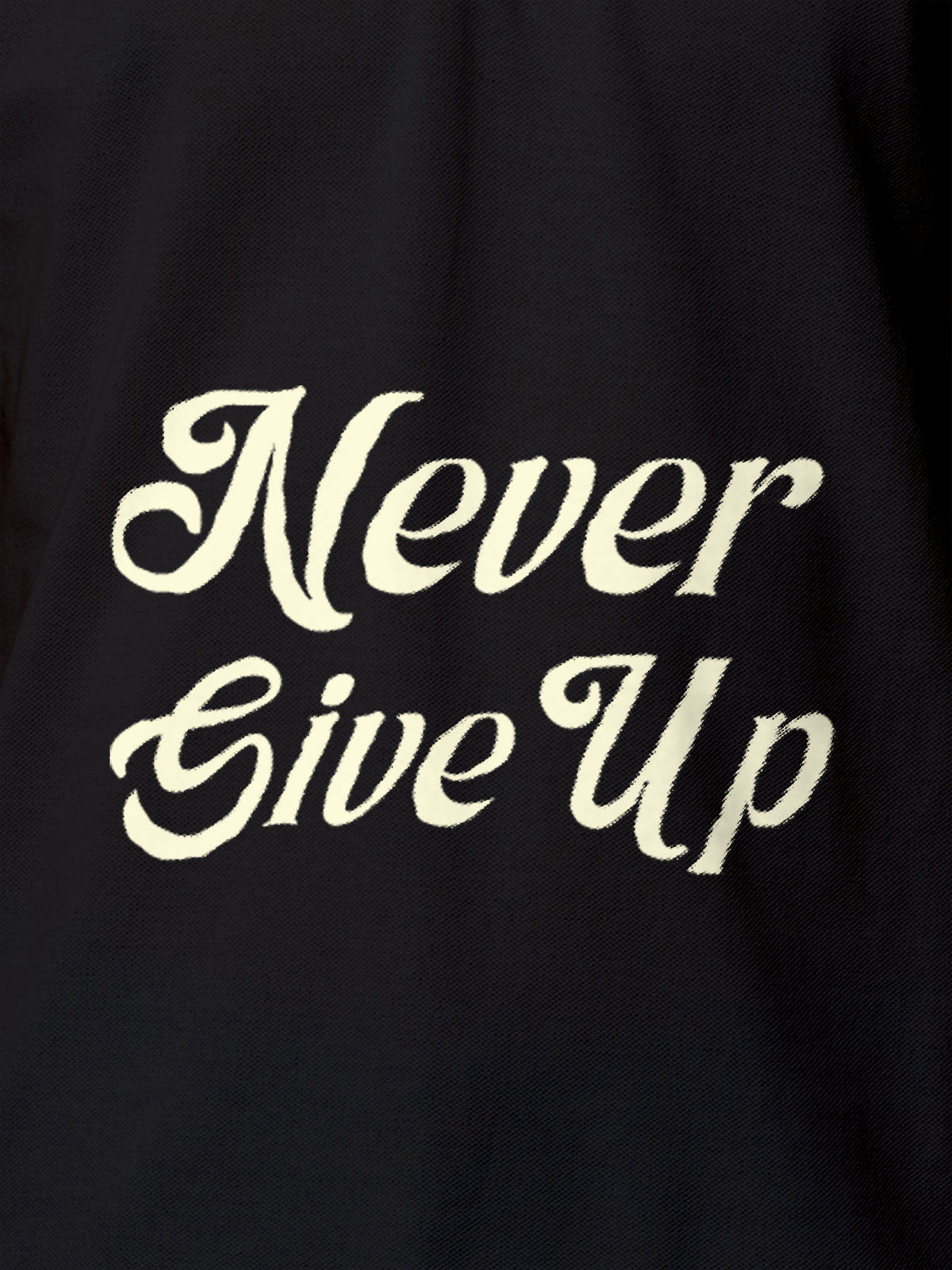 Close up of 'Never Give Up' design on Men's Dark Grey Polo T-shirt, highlighting intricate details and vibrant print.
