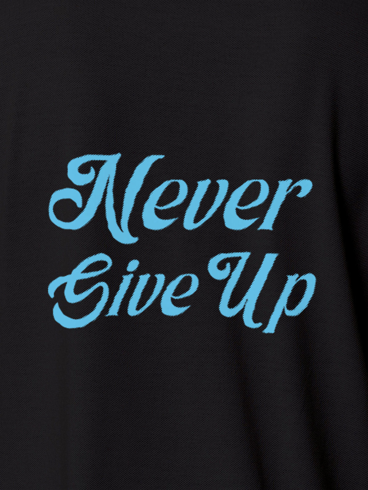 Close up of 'Never Give Up' design on Women's Dark Grey Polo T-shirt, highlighting intricate details and vibrant print.