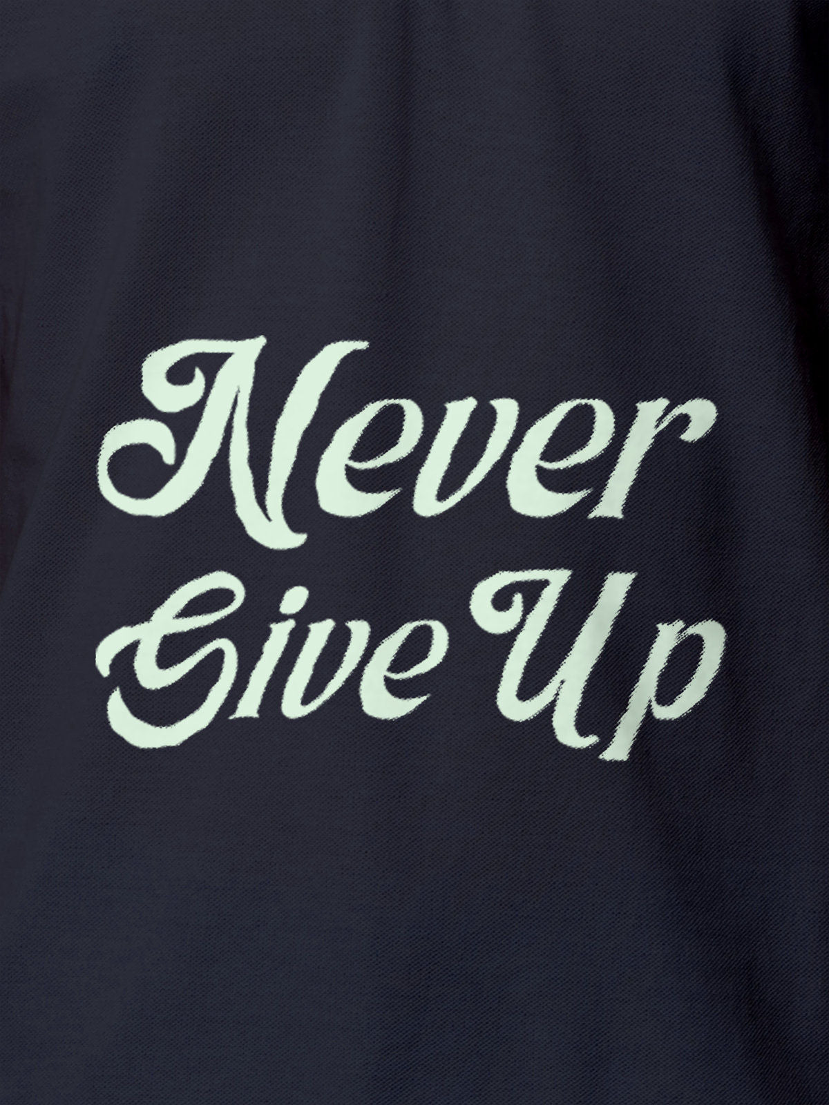 Close up of 'Never Give Up' design on Men's Navy Blue Polo T-shirt, highlighting intricate details and vibrant print.