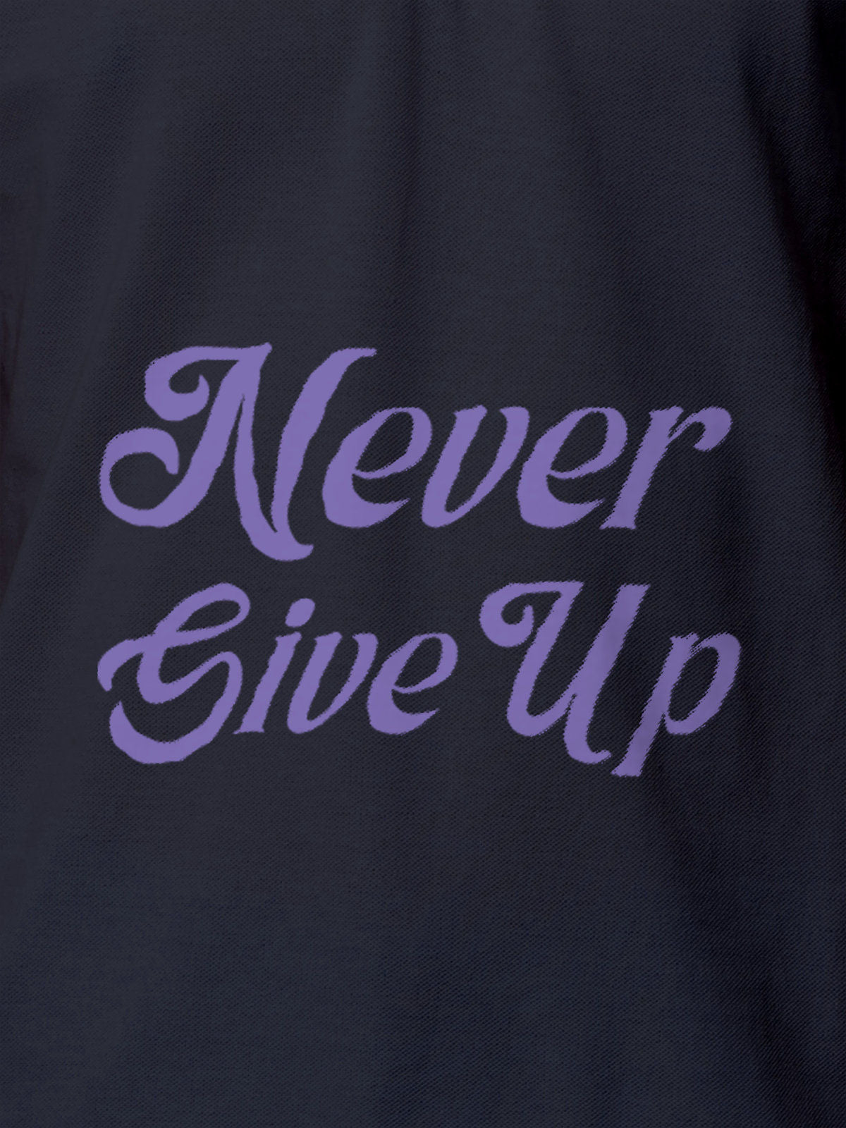 Close up of 'Never Give Up' design on Men's Navy Blue Polo T-shirt, highlighting intricate details and vibrant print.