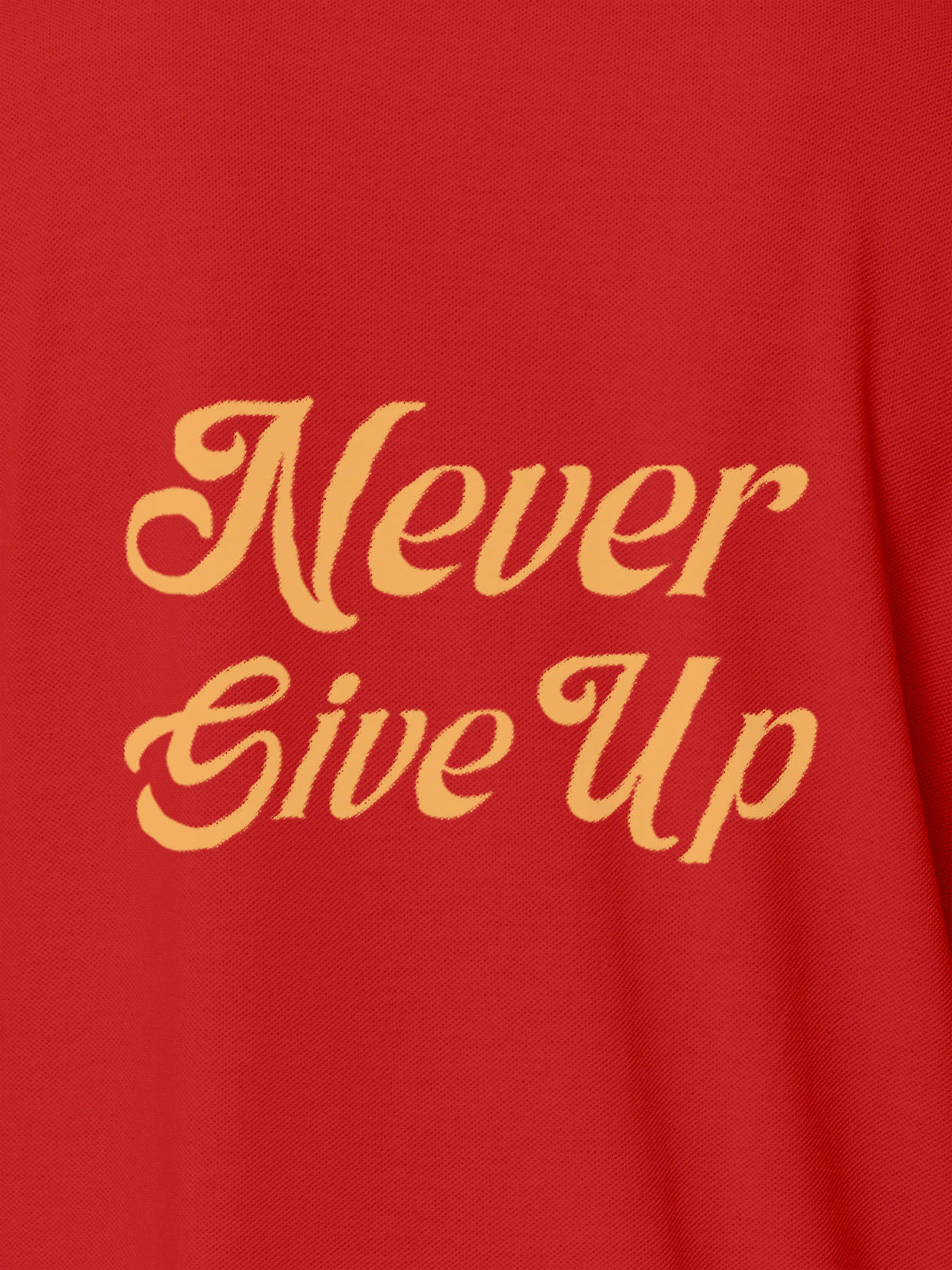 Close up of 'Never Give Up' design on Women's Red Polo T-shirt, highlighting intricate details and vibrant print.