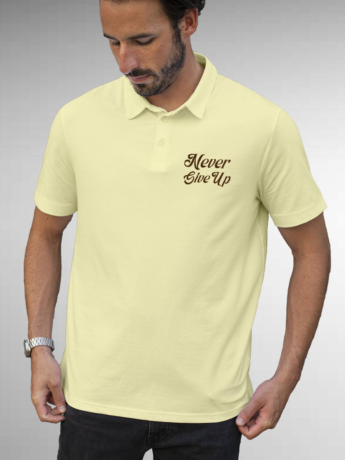 Model wearing Men's Yellow Polo T-shirt with 'Never Give Up' design, offering effortless style and premium comfort