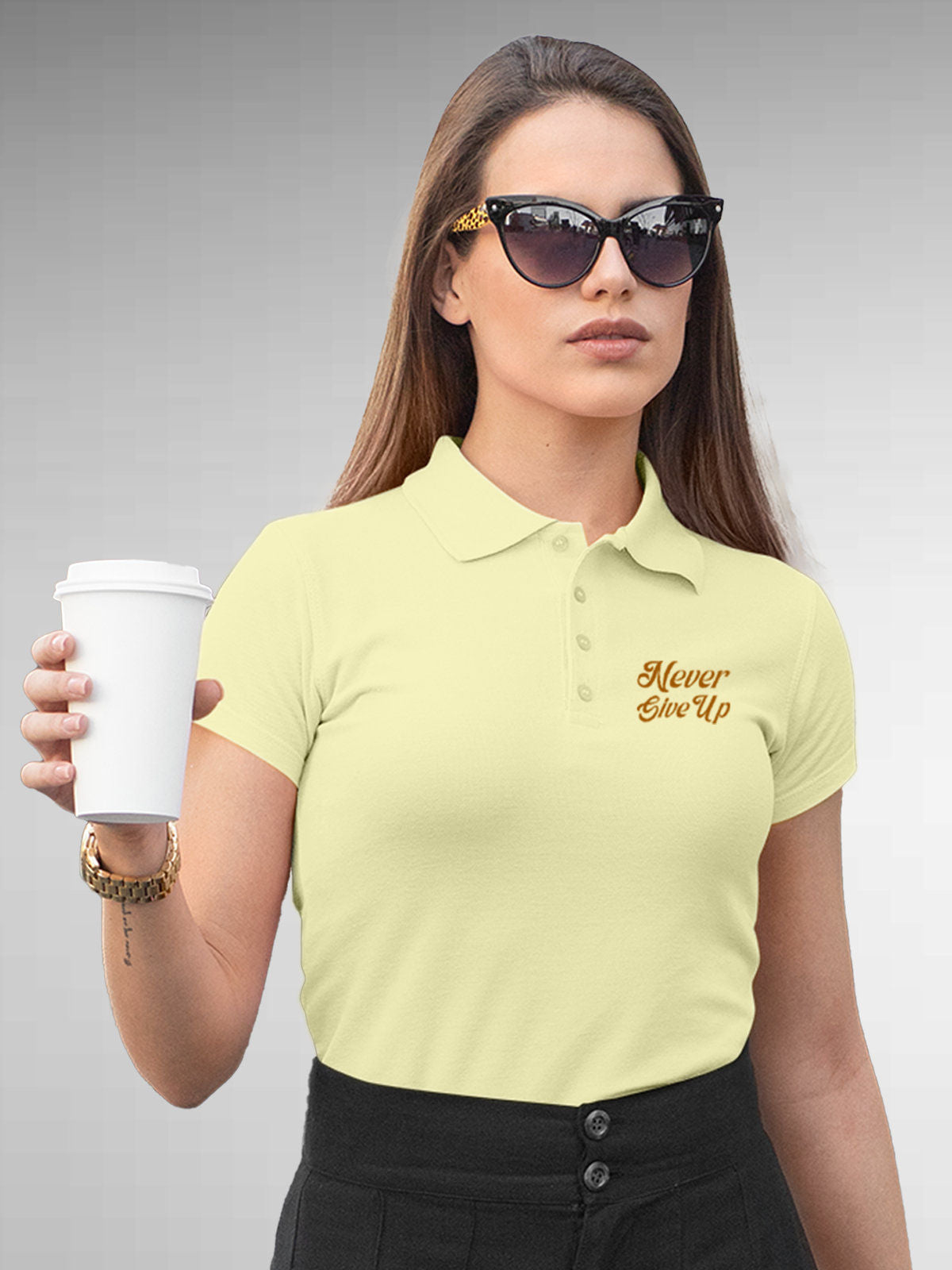 Model wearing Women's Yellow Polo T-shirt with 'Never Give Up' design, offering effortless style and premium comfort