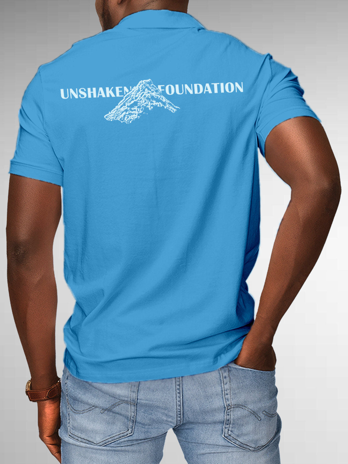 Model wearing Men's Blue Polo T-shirt with 'Unshaken Foundation' design, offering effortless style and premium comfort