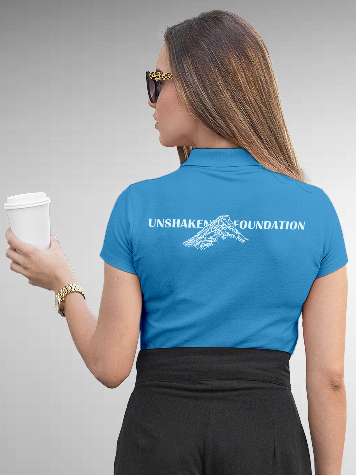 Model wearing Women's Blue Polo T-shirt with 'Unshaken Foundation' design, offering effortless style and premium comfort