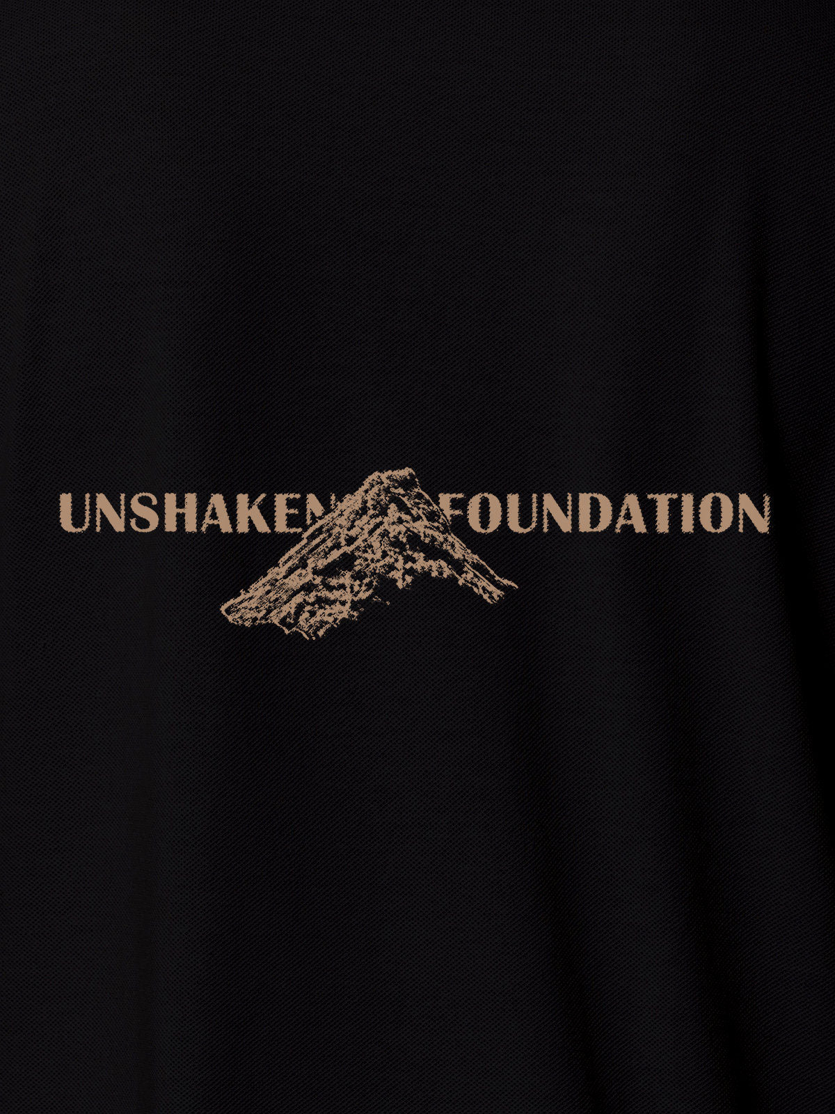 Close up of 'Unshaken Foundation' design on Men's Black Polo T-shirt, highlighting intricate details and vibrant print.