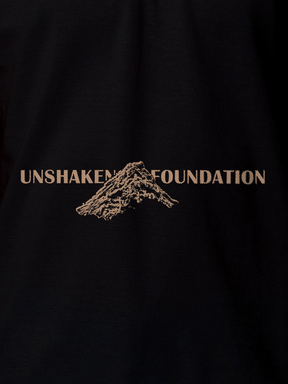 Close up of 'Unshaken Foundation' design on Women's Black Polo T-shirt, highlighting intricate details and vibrant print.