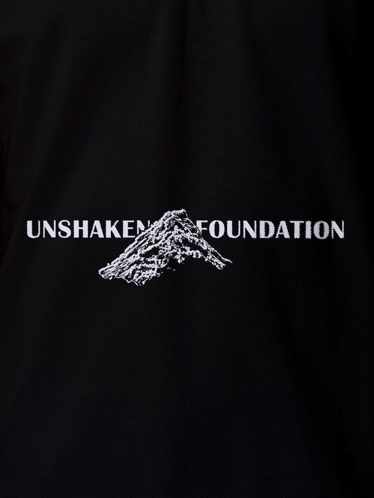 Close up of 'Unshaken Foundation' design on Women's Black Polo T-shirt, highlighting intricate details and vibrant print.