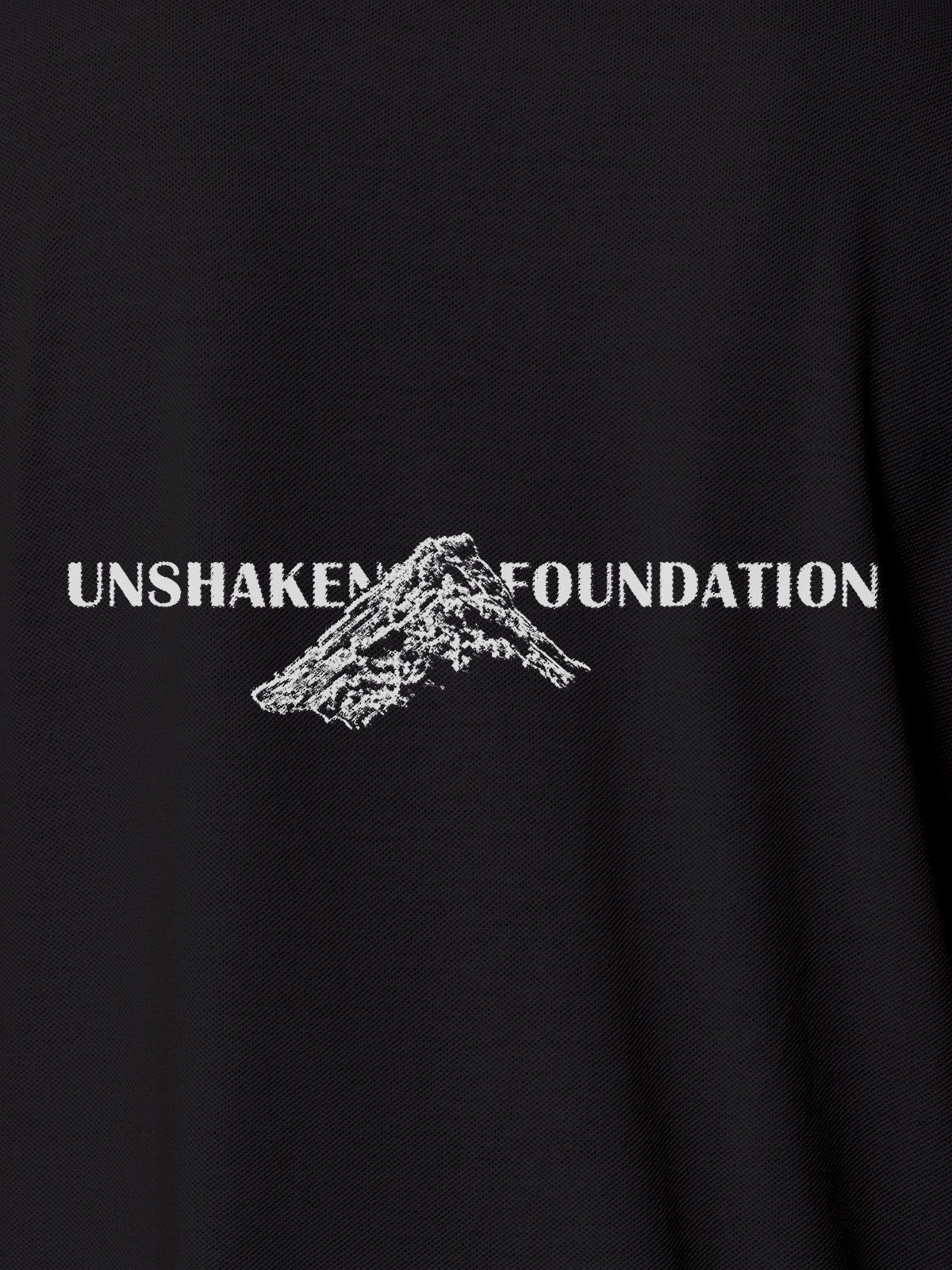 Close up of 'Unshaken Foundation' design on Men's Dark Grey Polo T-shirt, highlighting intricate details and vibrant print.