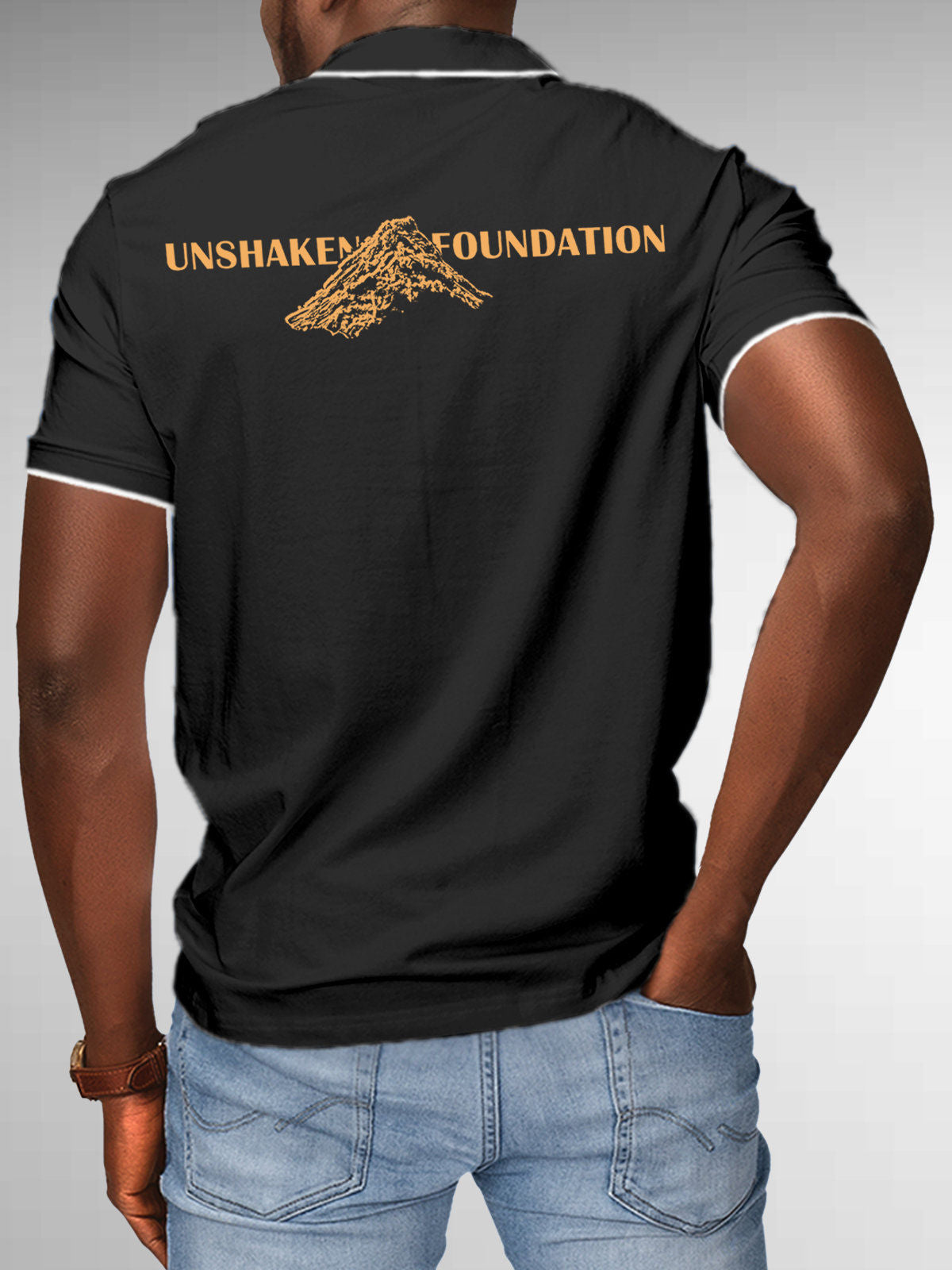 Model wearing Men's Dark Grey Polo T-shirt with 'Unshaken Foundation' design, offering effortless style and premium comfort