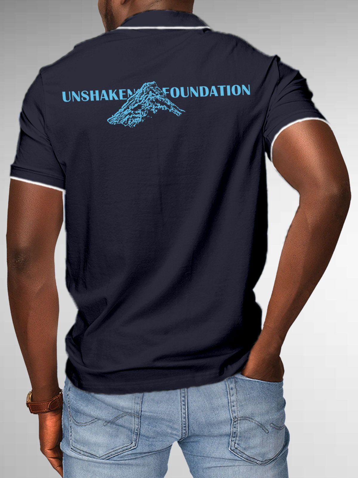 Model wearing Men's Navy Blue Polo T-shirt with 'Unshaken Foundation' design, offering effortless style and premium comfort