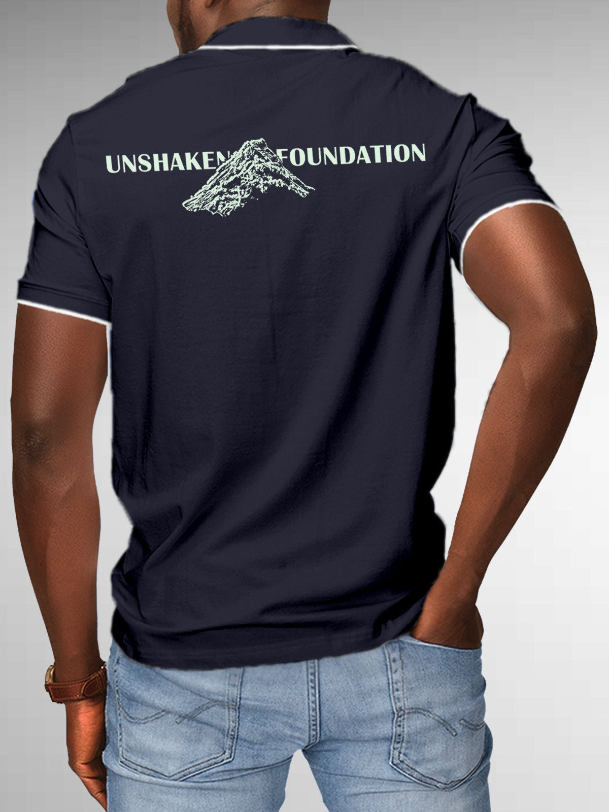 Model wearing Men's Navy Blue Polo T-shirt with 'Unshaken Foundation' design, offering effortless style and premium comfort