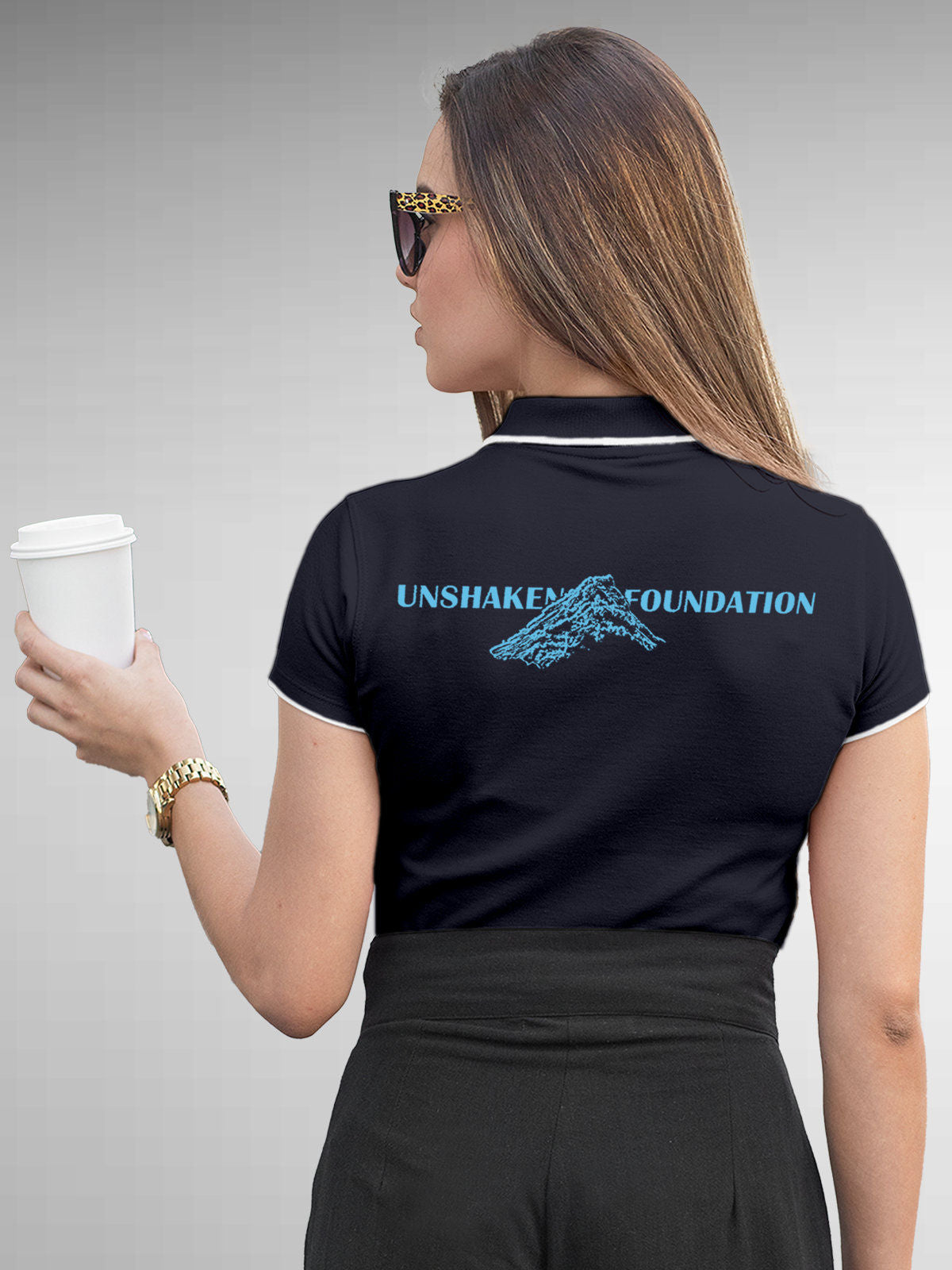 Model wearing Women's Navy Blue Polo T-shirt with 'Unshaken Foundation' design, offering effortless style and premium comfort