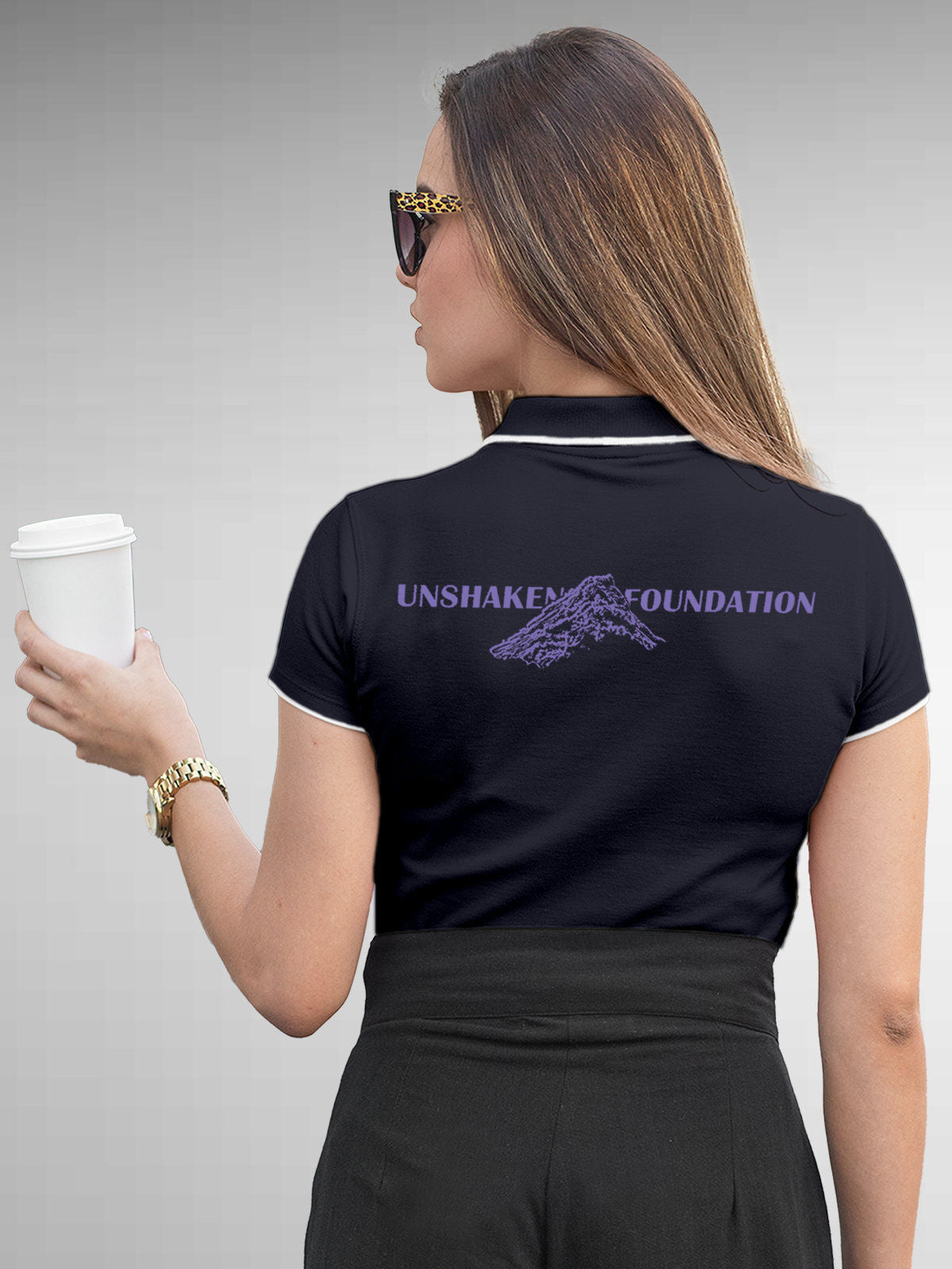 Model wearing Women's Navy Blue Polo T-shirt with 'Unshaken Foundation' design, offering effortless style and premium comfort