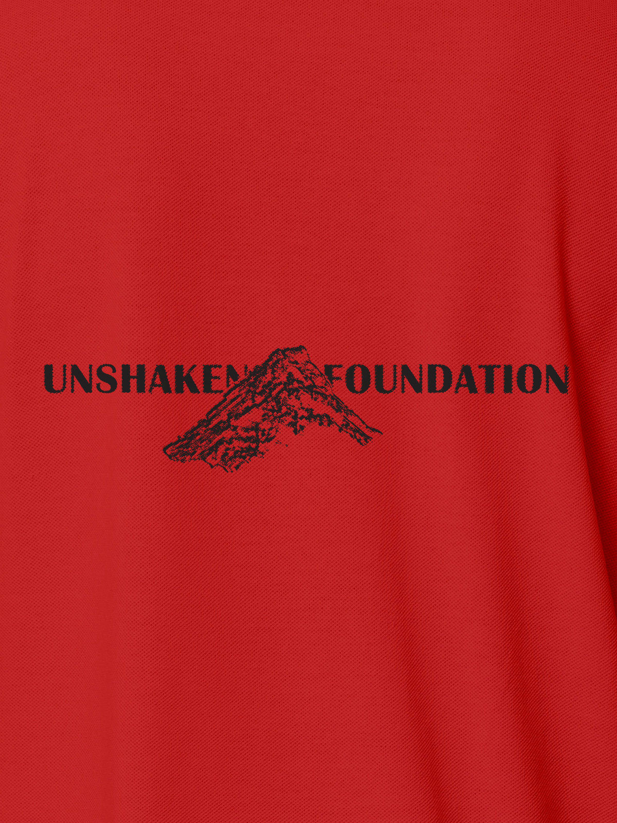 Close up of 'Unshaken Foundation' design on Men's Red Polo T-shirt, highlighting intricate details and vibrant print.