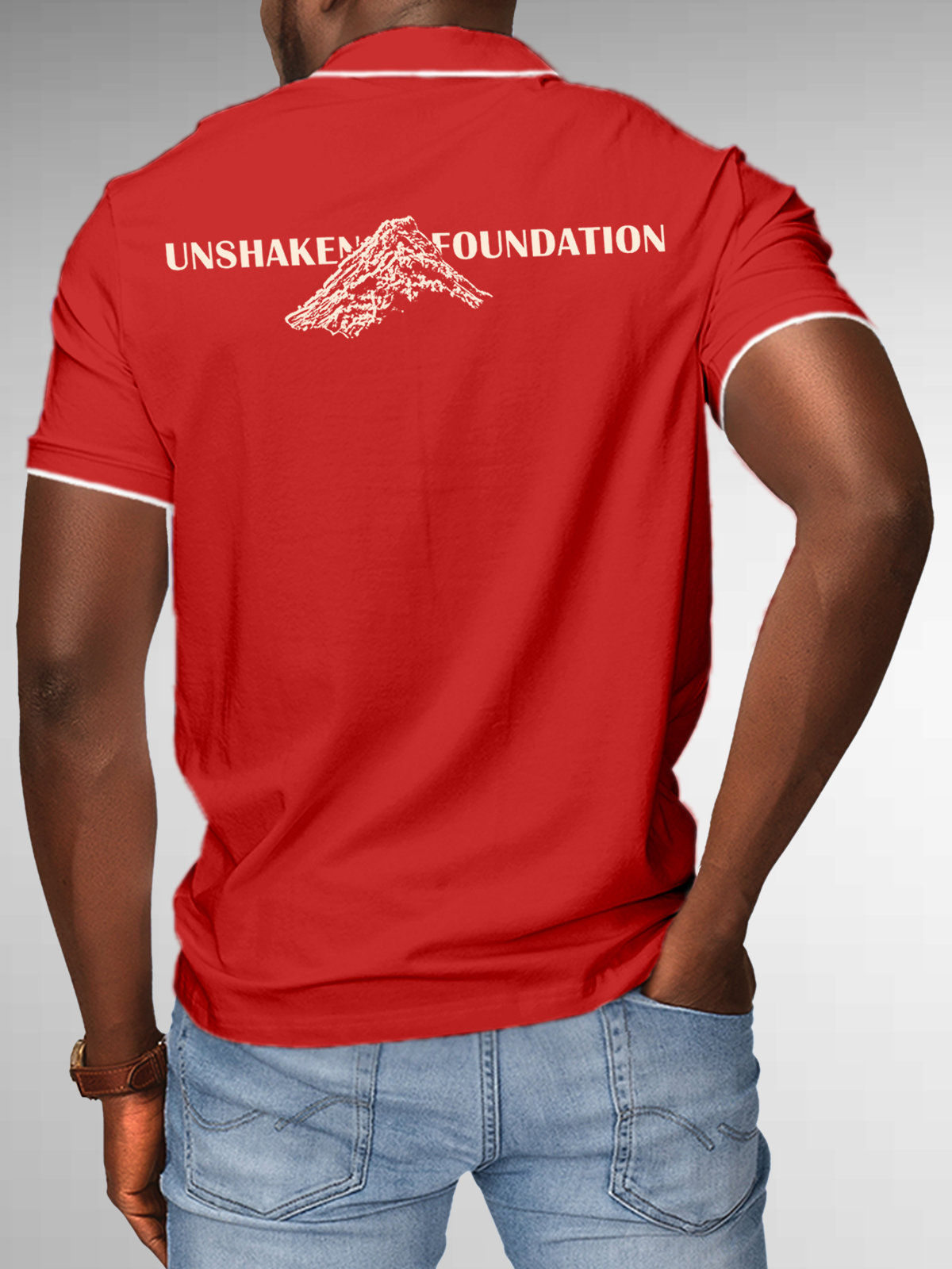 Model wearing Men's Red Polo T-shirt with 'Unshaken Foundation' design, offering effortless style and premium comfort