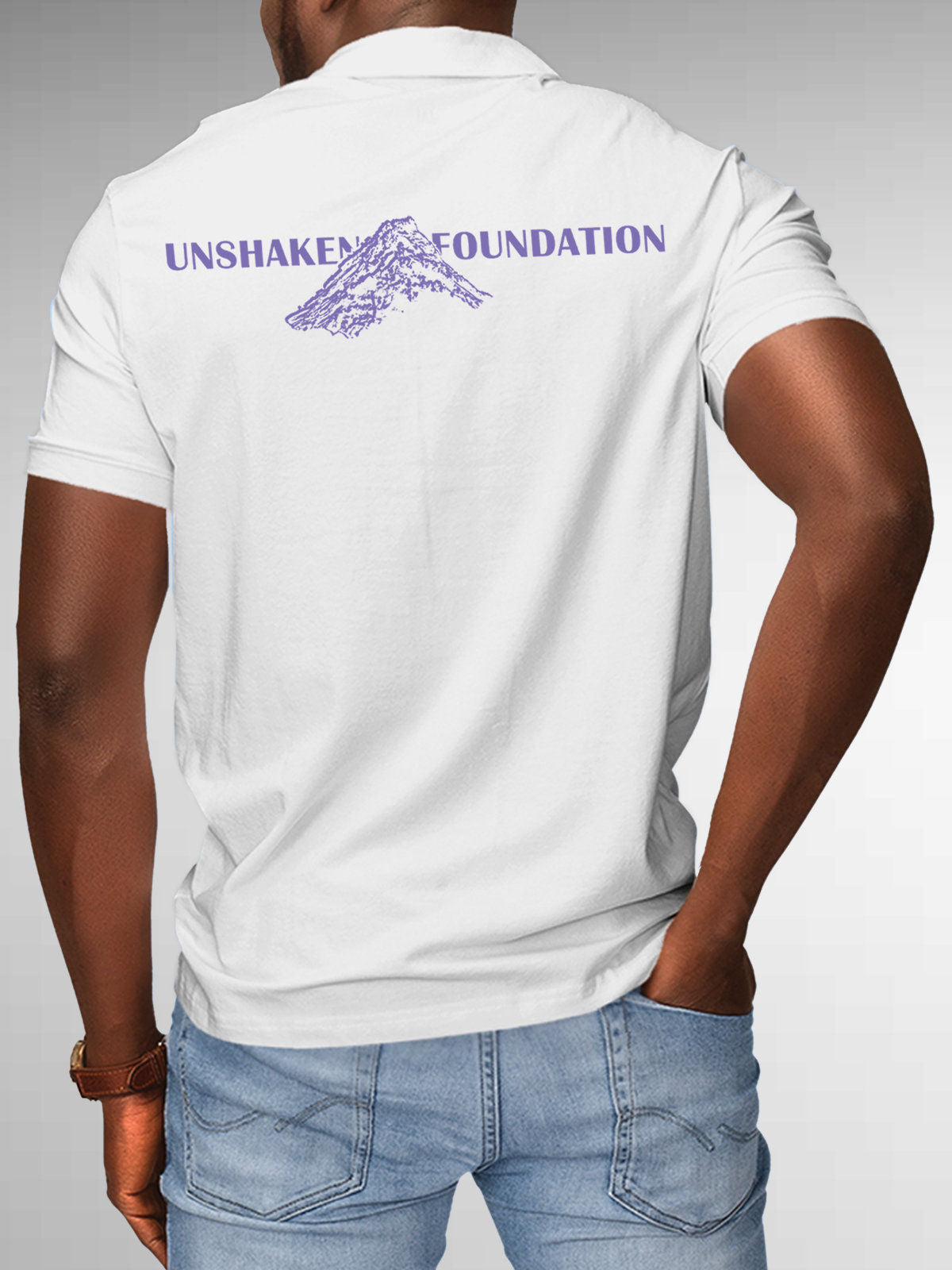 Model wearing Men's White Polo T-shirt with 'Unshaken Foundation' design, offering effortless style and premium comfort