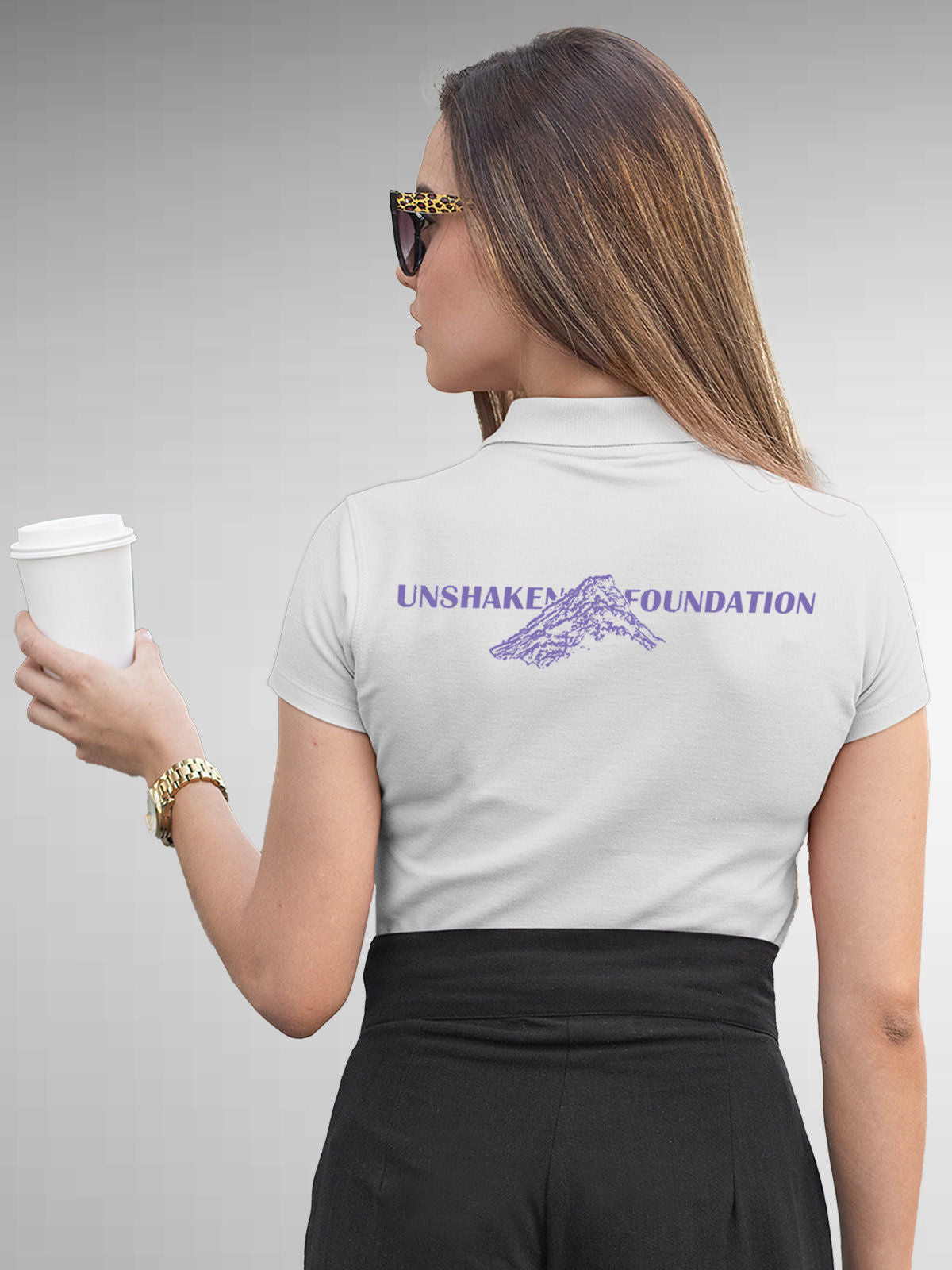Model wearing Women's White Polo T-shirt with 'Unshaken Foundation' design, offering effortless style and premium comfort