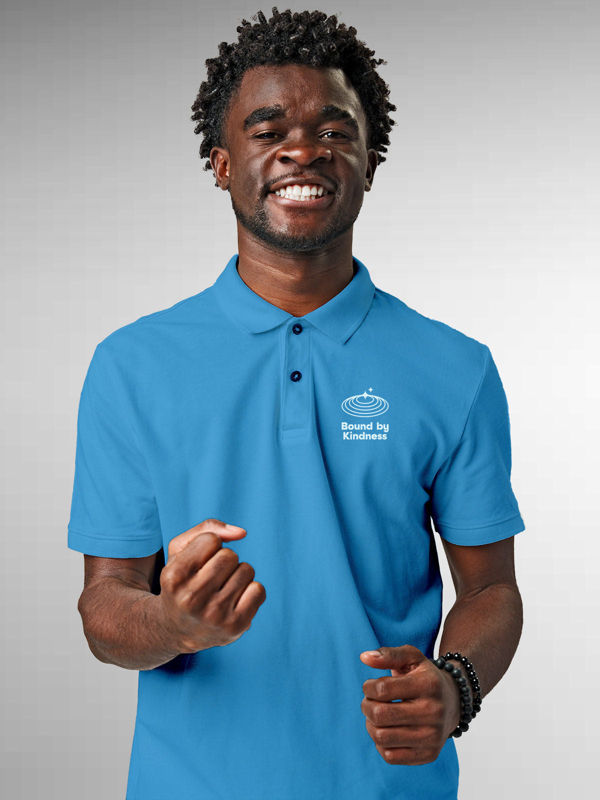 Model wearing Men's Blue Polo T-shirt with 'Bound By Kindness' design, offering effortless style and premium comfort