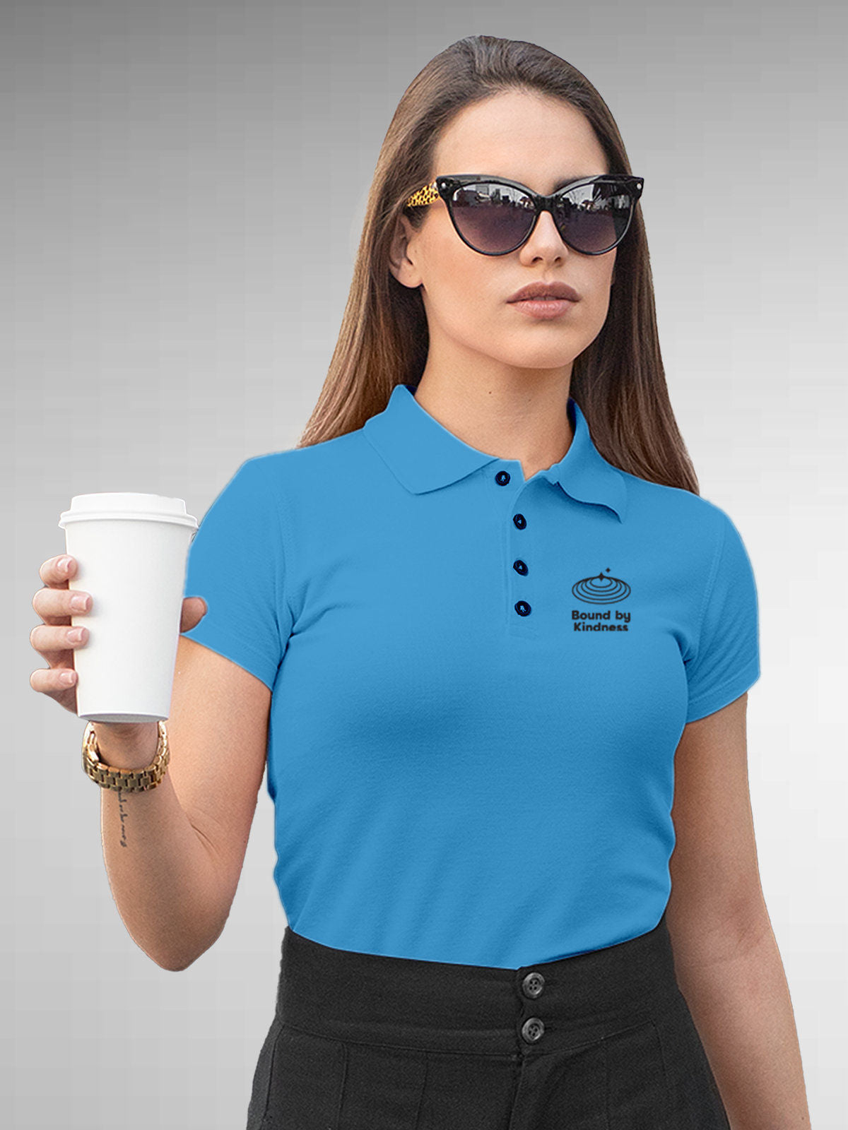 Model wearing Women's Blue Polo T-shirt with 'Bound By Kindness' design, offering effortless style and premium comfort