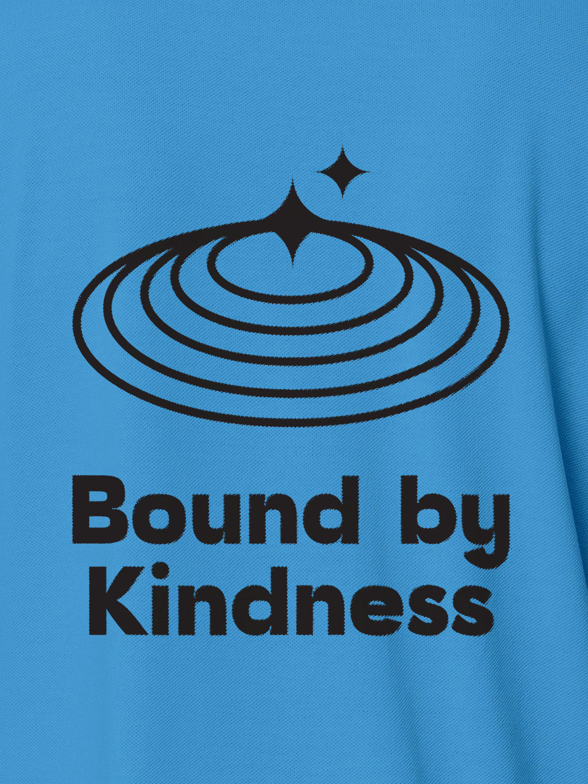Close up of 'Bound By Kindness' design on Women's Blue Polo T-shirt, highlighting intricate details and vibrant print.
