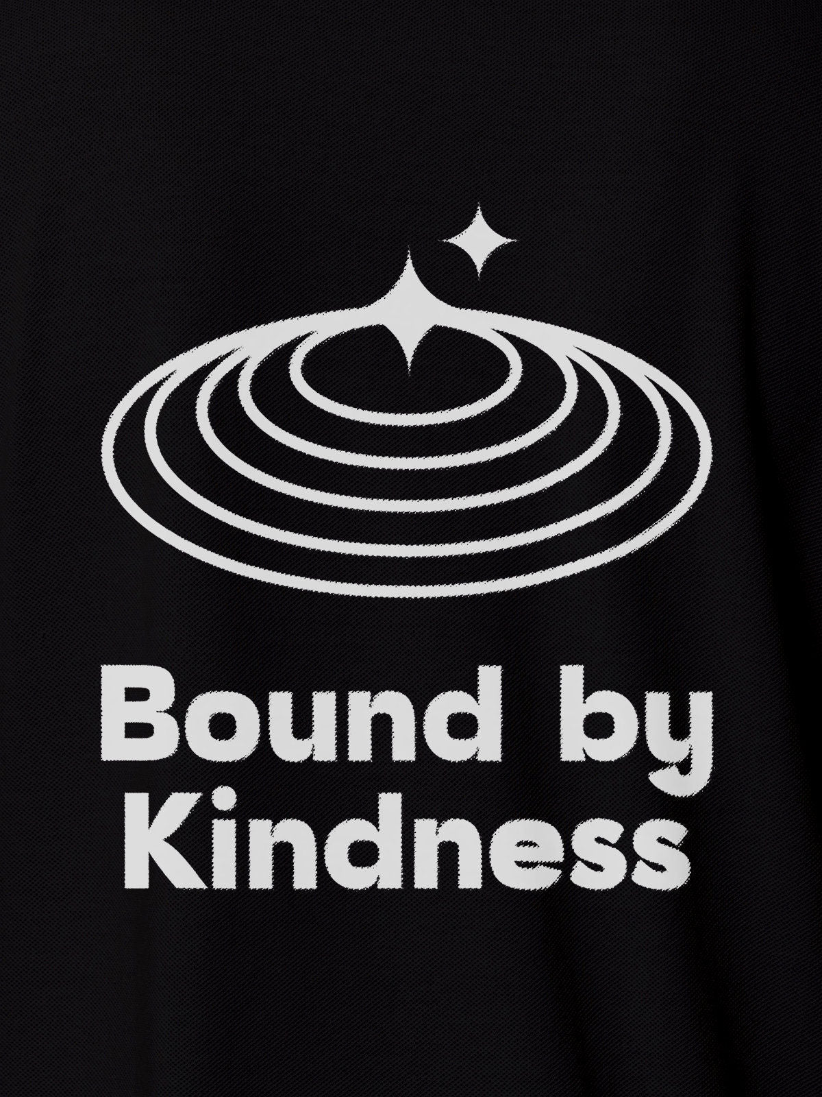 Close up of 'Bound By Kindness' design on Women's Black Polo T-shirt, highlighting intricate details and vibrant print.