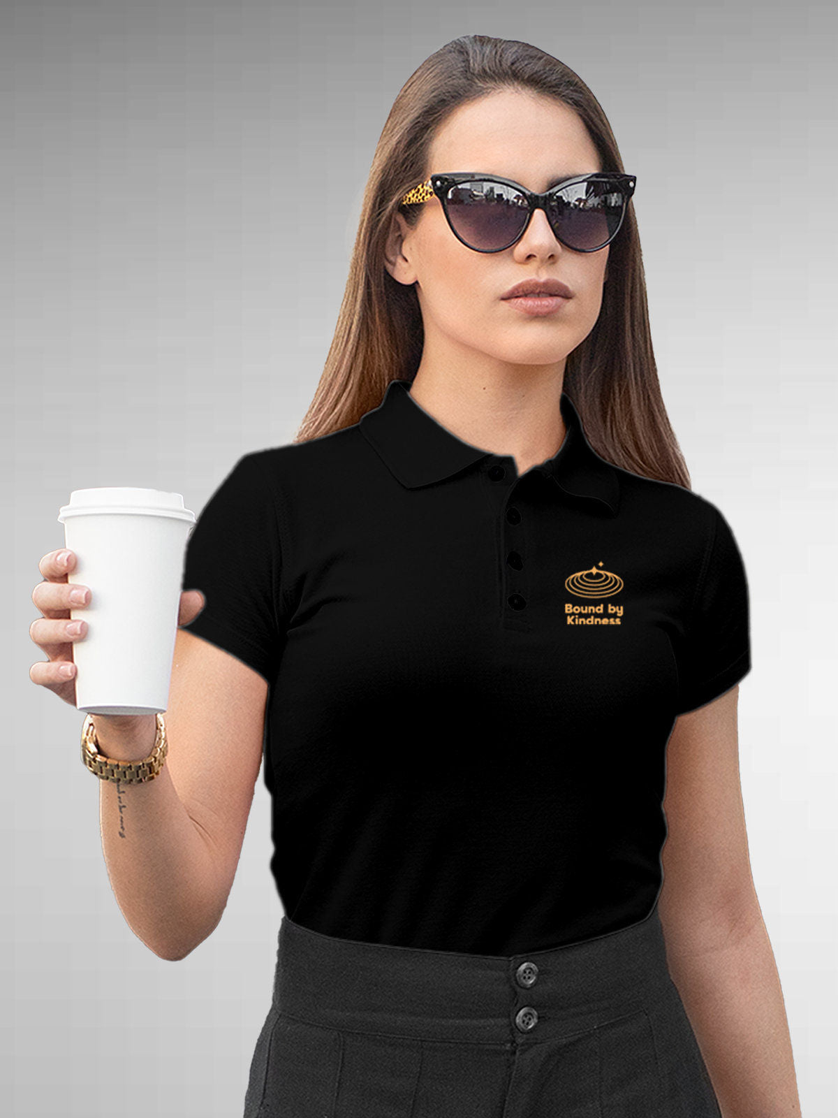 Model wearing Women's Black Polo T-shirt with 'Bound By Kindness' design, offering effortless style and premium comfort