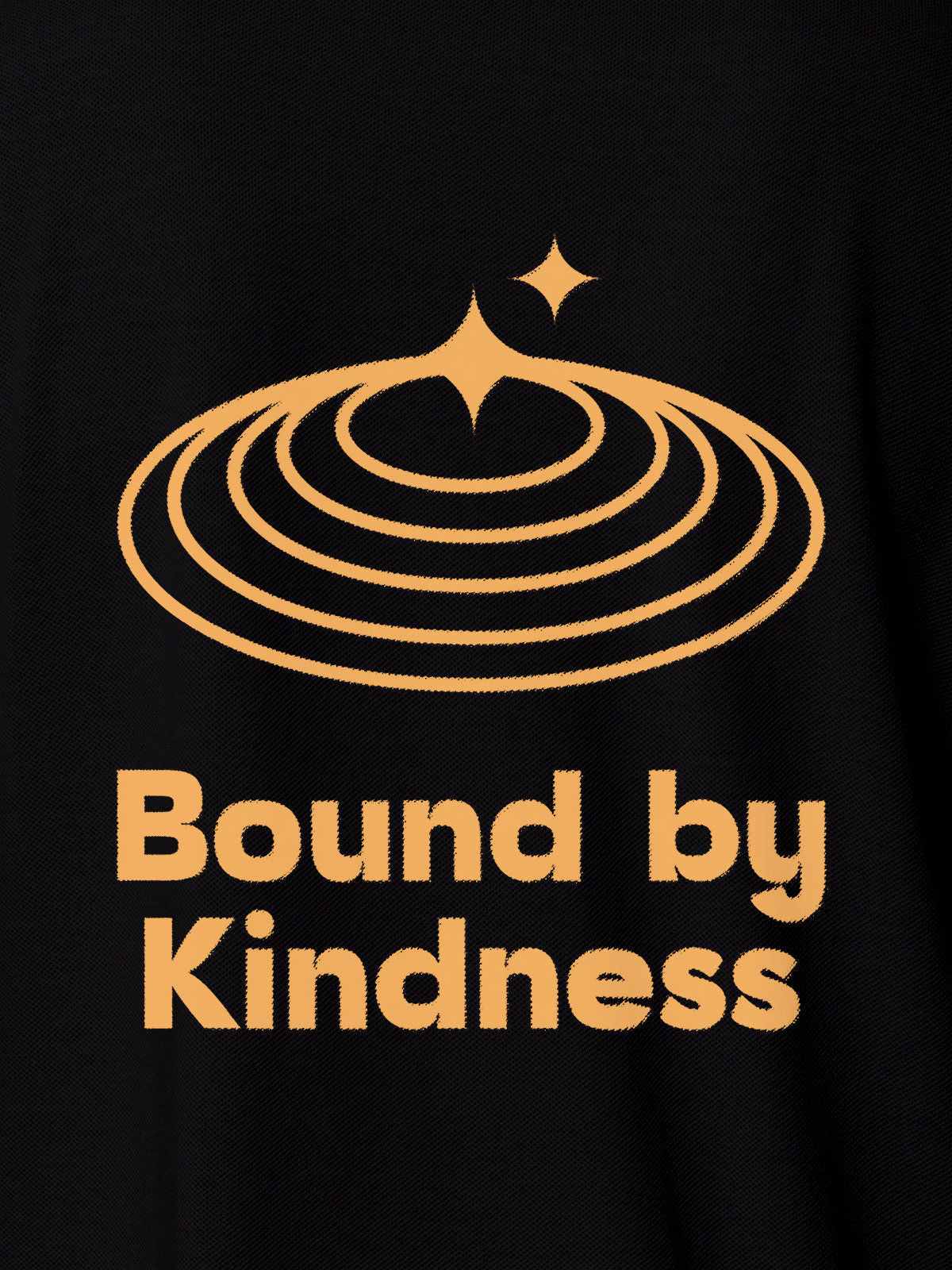 Close up of 'Bound By Kindness' design on Women's Black Polo T-shirt, highlighting intricate details and vibrant print.