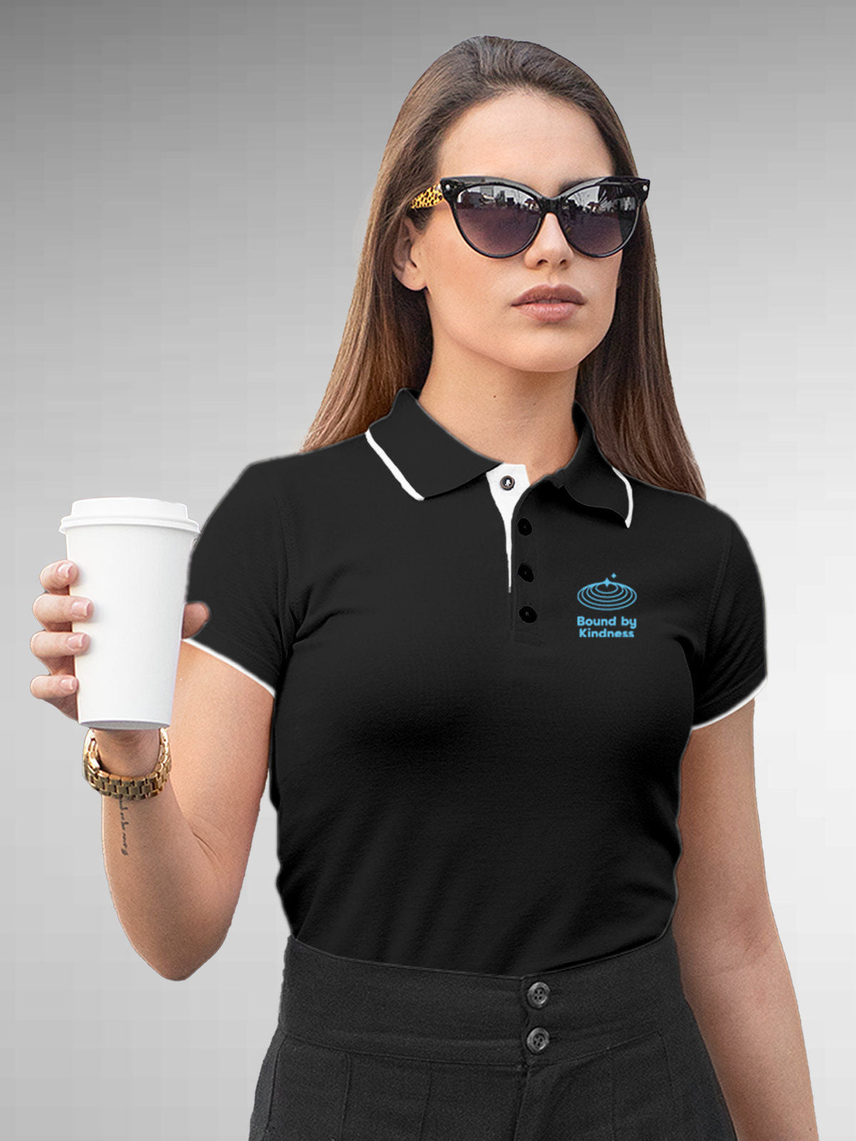 Model wearing Women's Dark Grey Polo T-shirt with 'Bound By Kindness' design, offering effortless style and premium comfort