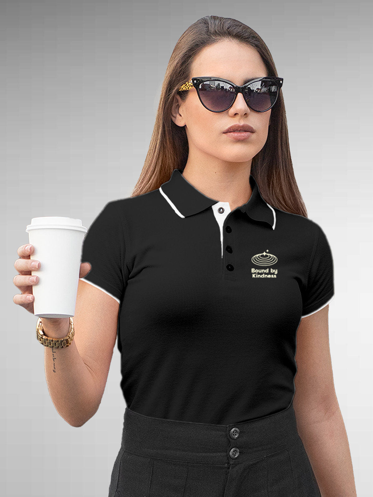 Model wearing Women's Dark Grey Polo T-shirt with 'Bound By Kindness' design, offering effortless style and premium comfort