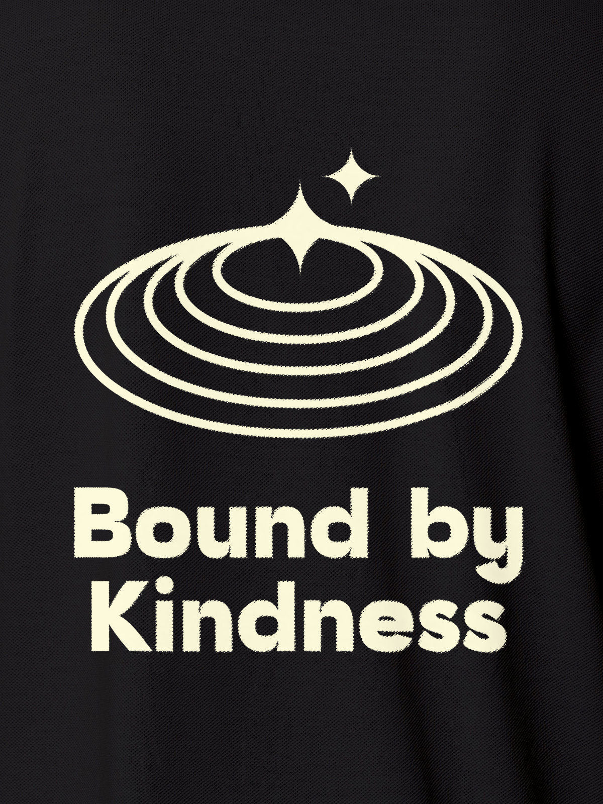 Close up of 'Bound By Kindness' design on Women's Dark Grey Polo T-shirt, highlighting intricate details and vibrant print.