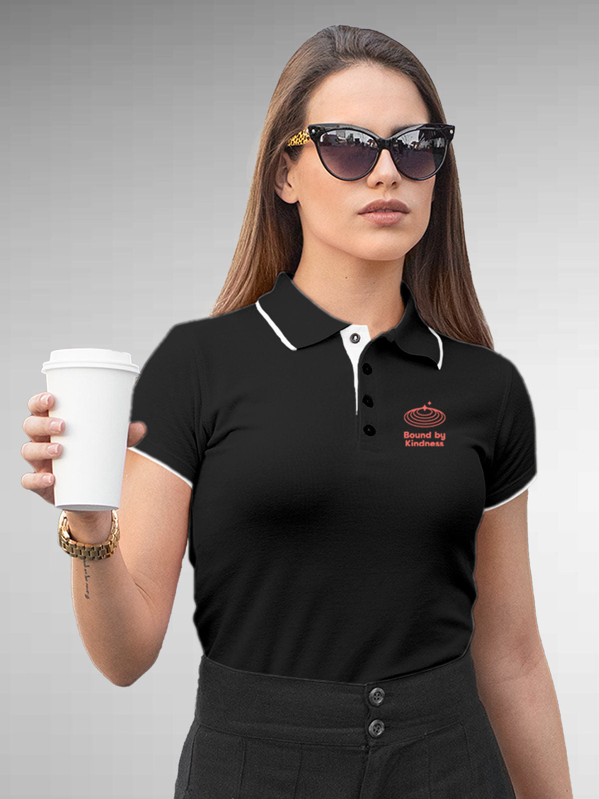 Model wearing Women's Dark Grey Polo T-shirt with 'Bound By Kindness' design, offering effortless style and premium comfort