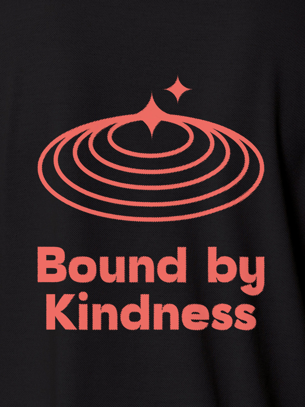 Close up of 'Bound By Kindness' design on Women's Dark Grey Polo T-shirt, highlighting intricate details and vibrant print.