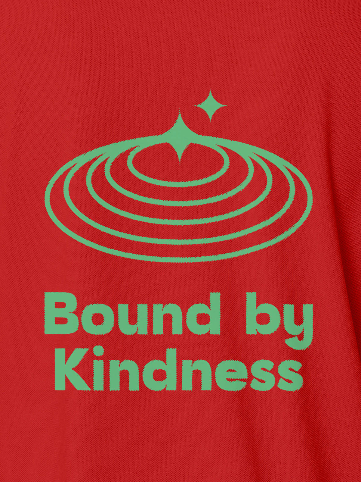 Close up of 'Bound By Kindness' design on Women's Red Polo T-shirt, highlighting intricate details and vibrant print.