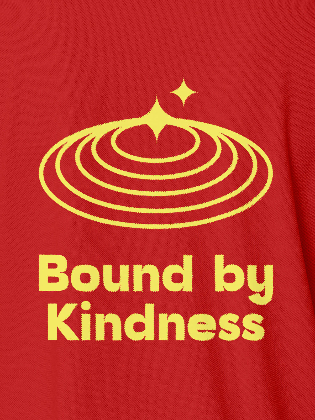 Close up of 'Bound By Kindness' design on Women's Red Polo T-shirt, highlighting intricate details and vibrant print.