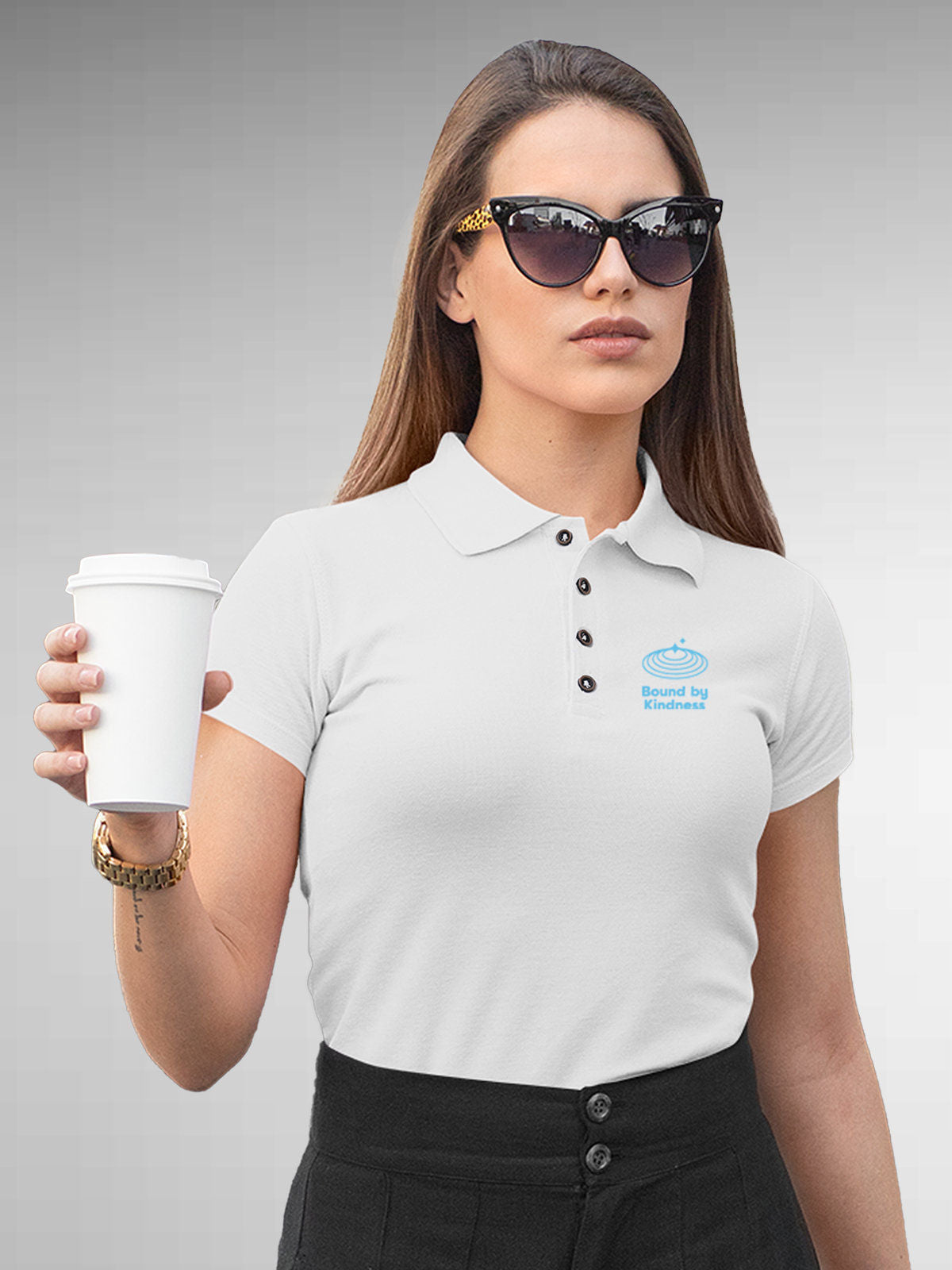 Model wearing Women's White Polo T-shirt with 'Bound By Kindness' design, offering effortless style and premium comfort